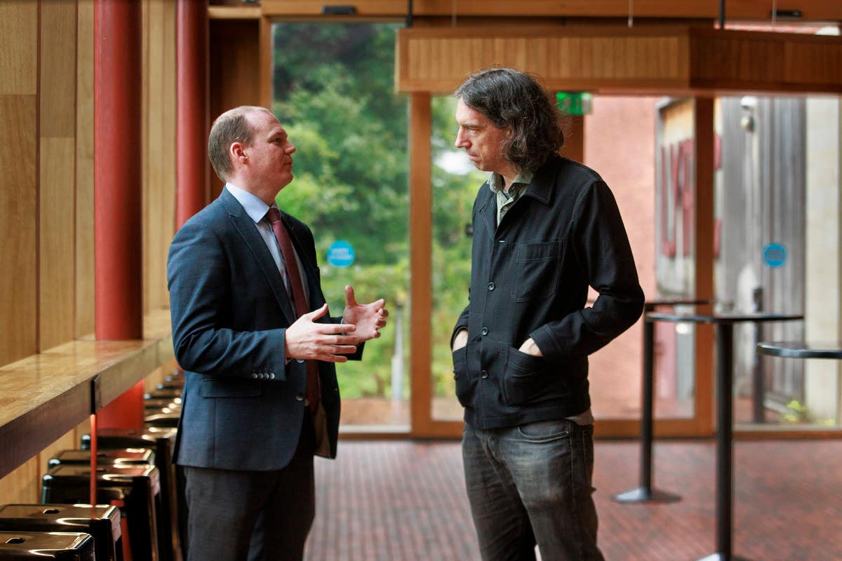 Communities Minister Gordon Lyons (left) with Gary Lightbody of Snow Patrol (Liam McBurney/PA)