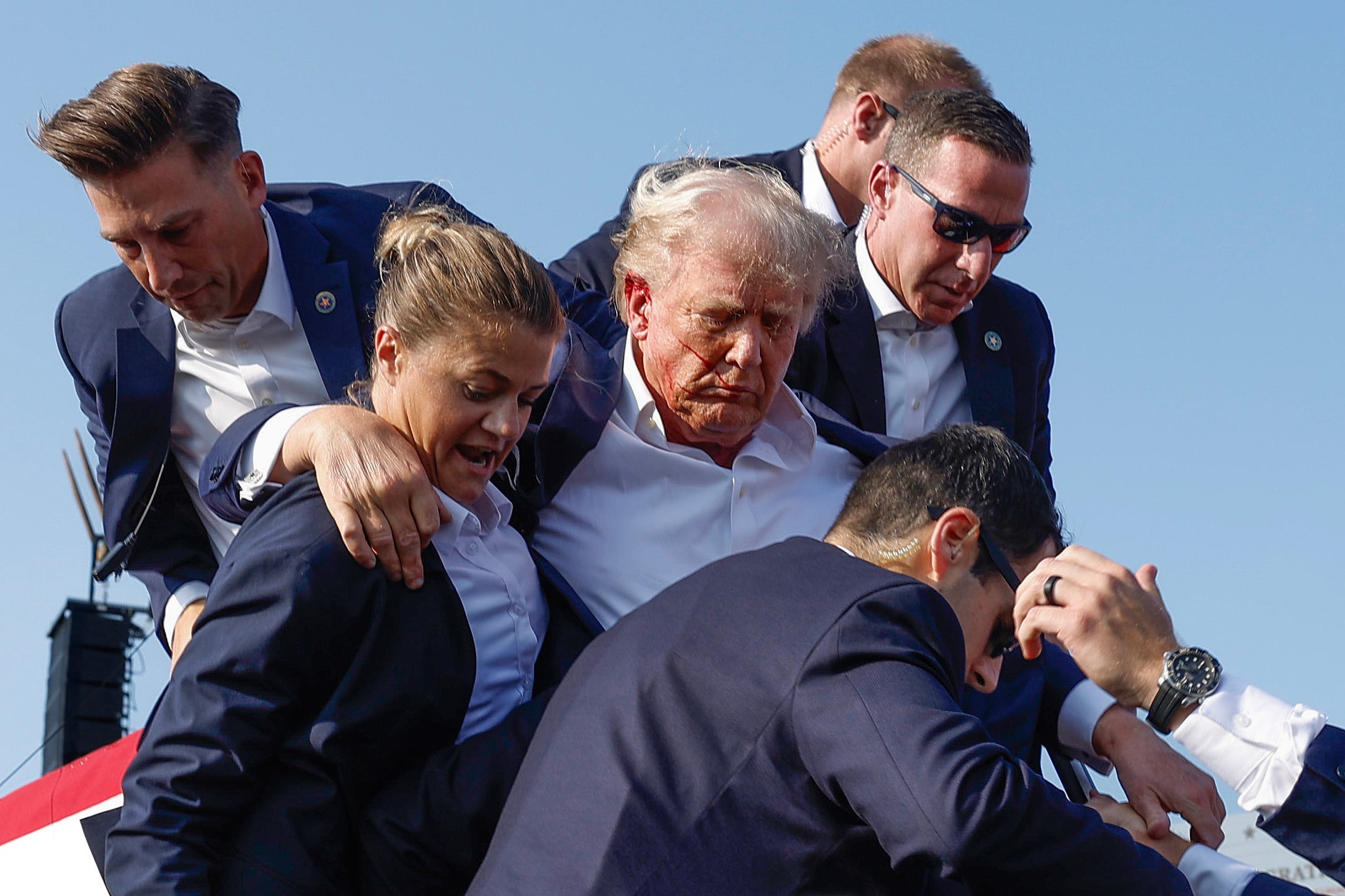 Republican presidential candidate former President Donald Trump is rushed offstage by U.S. Secret Service agents after being grazed by a bullet during a Pennsylvania rally. He has now canceled an outdoor rally in Wisconsin due to Secret Service shortages