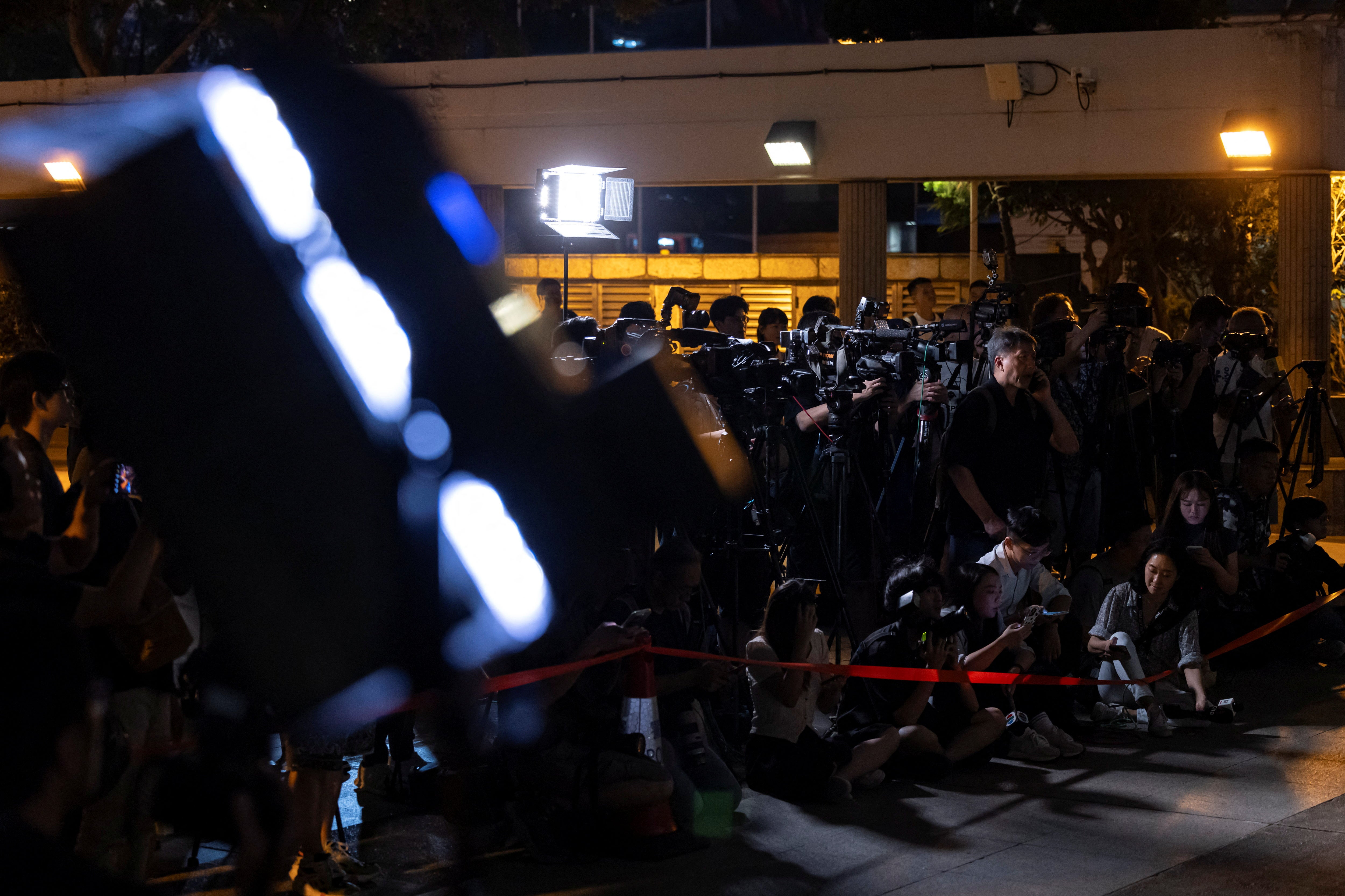 News reporters work outside the Hong Kong court where two former editors of Stand News were sentenced on 26 September 2024