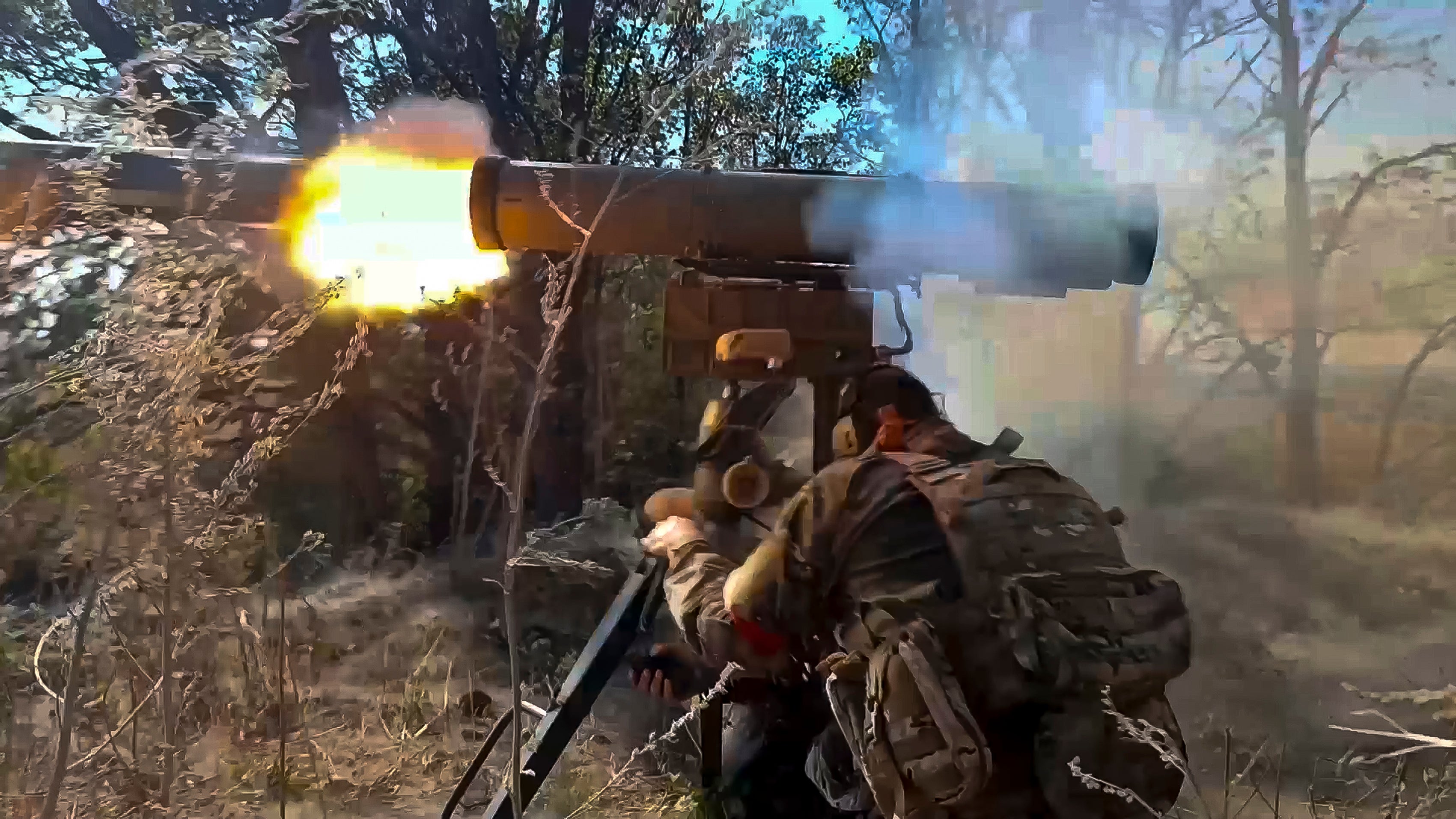 In this image made from video released by the Russian Defense Ministry, a Russian soldier in an undisclosed location fires an anti-tank missile at Ukrainian forces