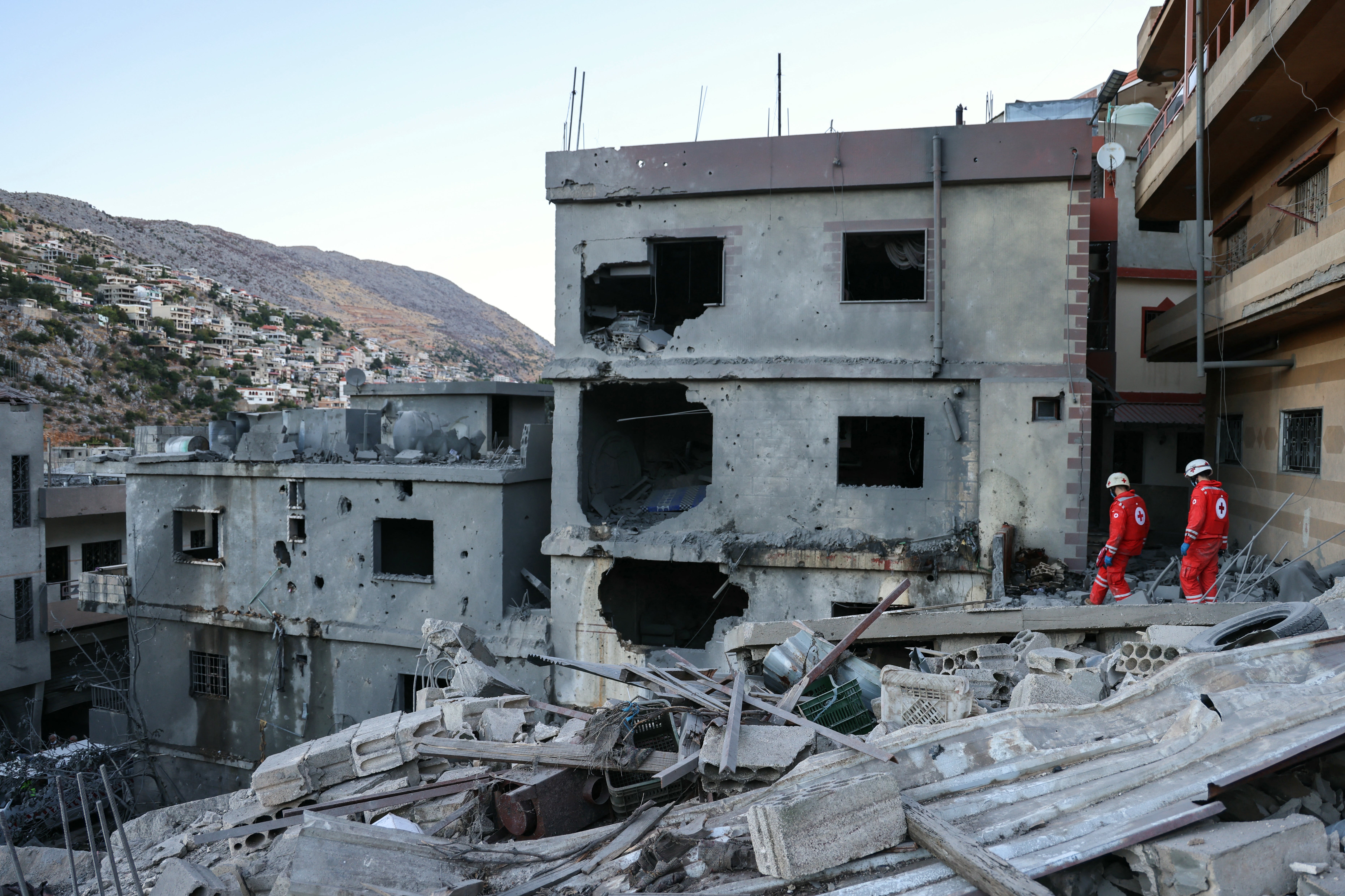 Rescuers check the destruction following an overnight Israeli airstrike in southern Lebanon