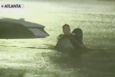 TV reporter interrupts live broadcast to rescue trapped woman during Hurricane Helene