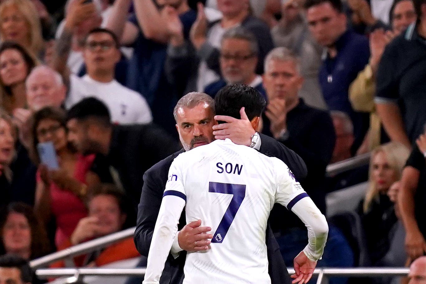 Son Heung-min is hugged by Tottenham manager Ange Postecoglou (John Walton/PA)