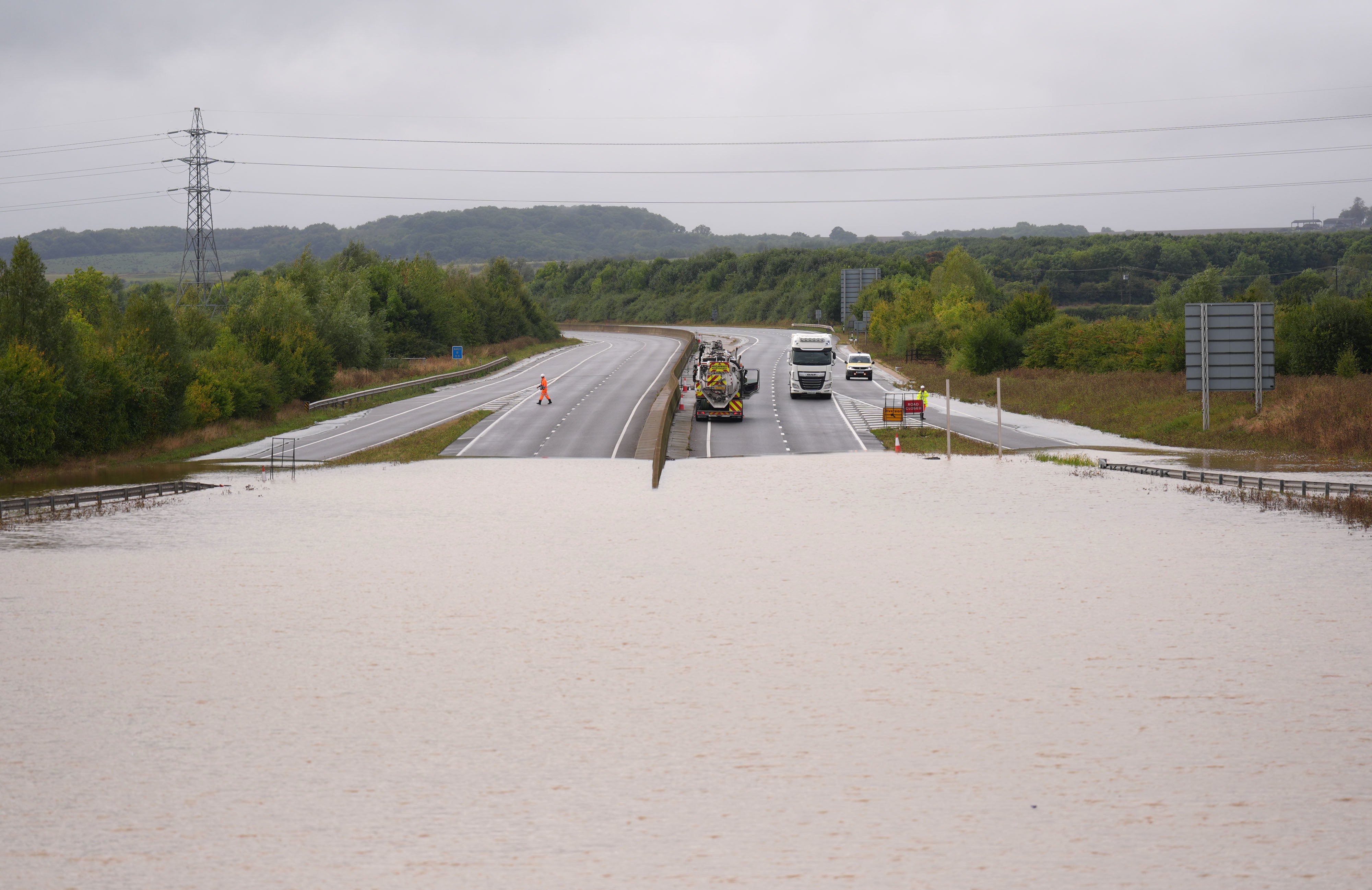 Flood water on the A421 in Marston Moretaine, Bedfordshire a week ago (PA)