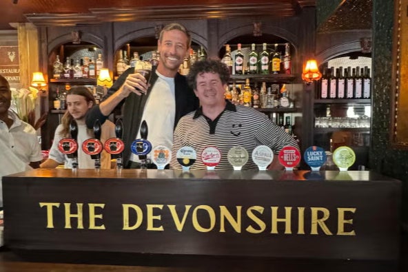 Peter Crouch pulling pints with landlord Oisin Rogers at The Devonshire in London
