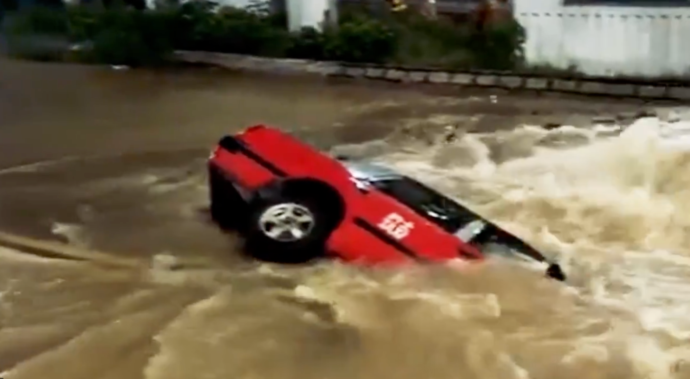 Hong Kong taxi plunges into sinkhole