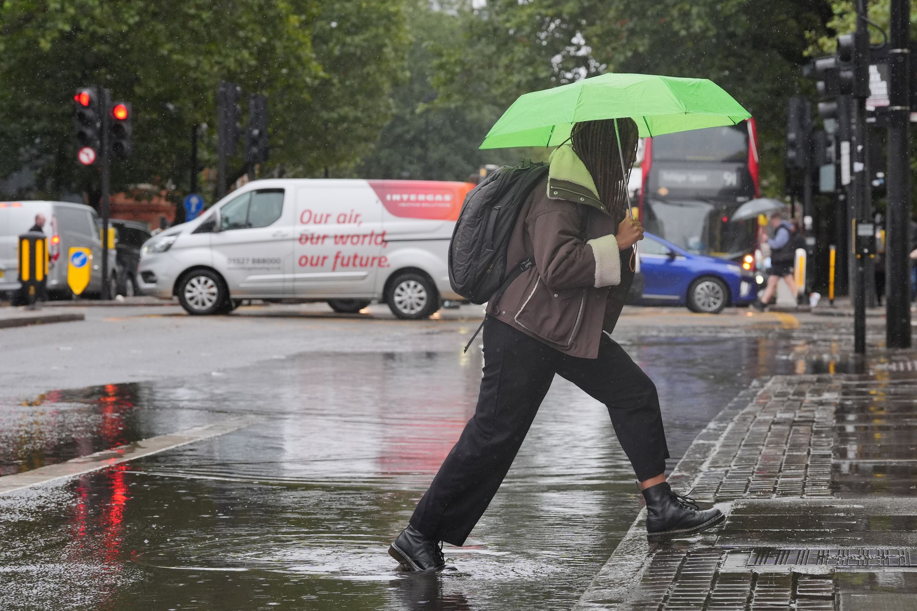 A person walks through a puddle on Euston Road in London (Jonathan Brady/PA)