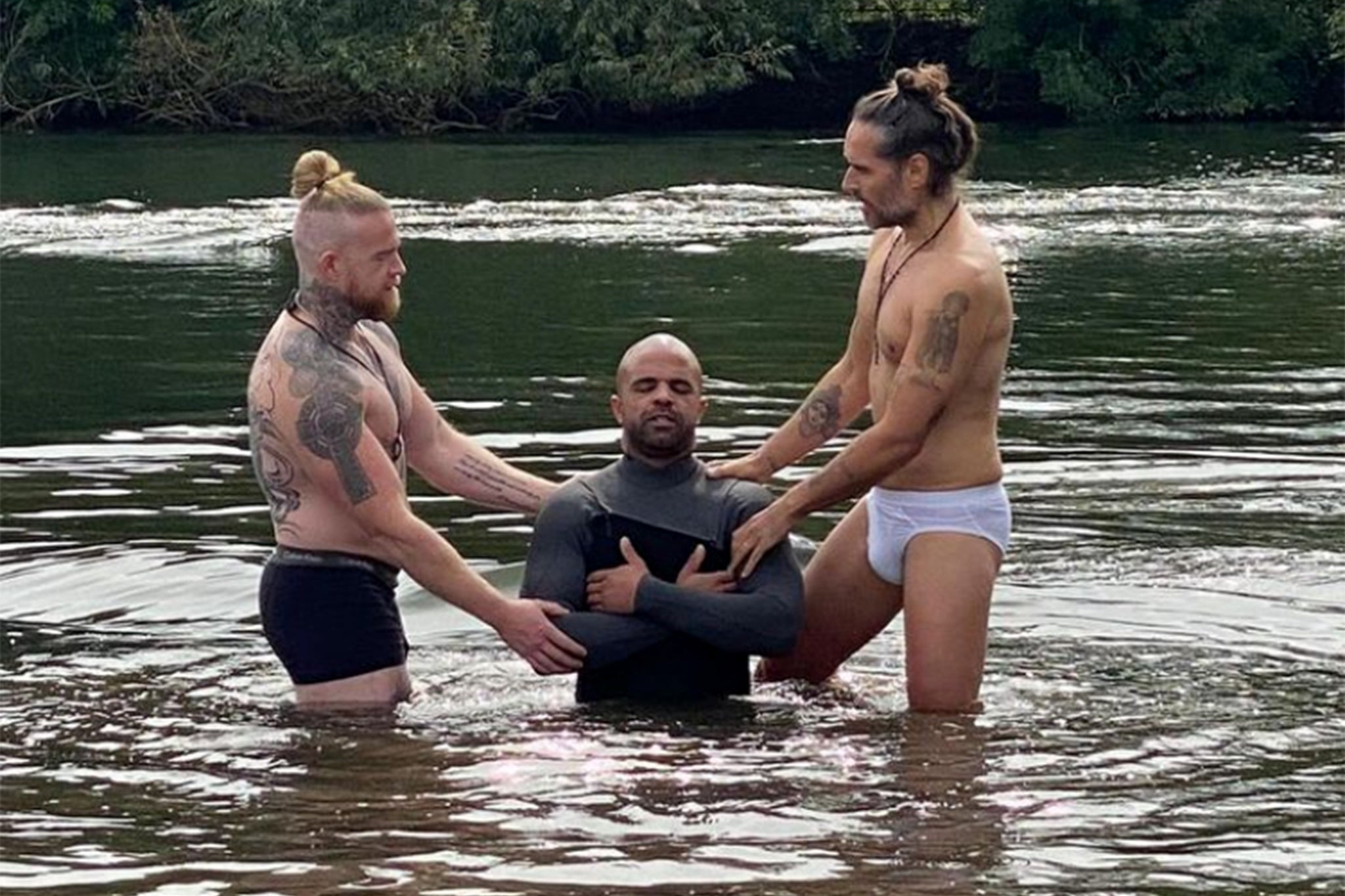 Russell Brand Brand posted the photos if him conducting a baptism in a lake wearing nothing but a pair of pants