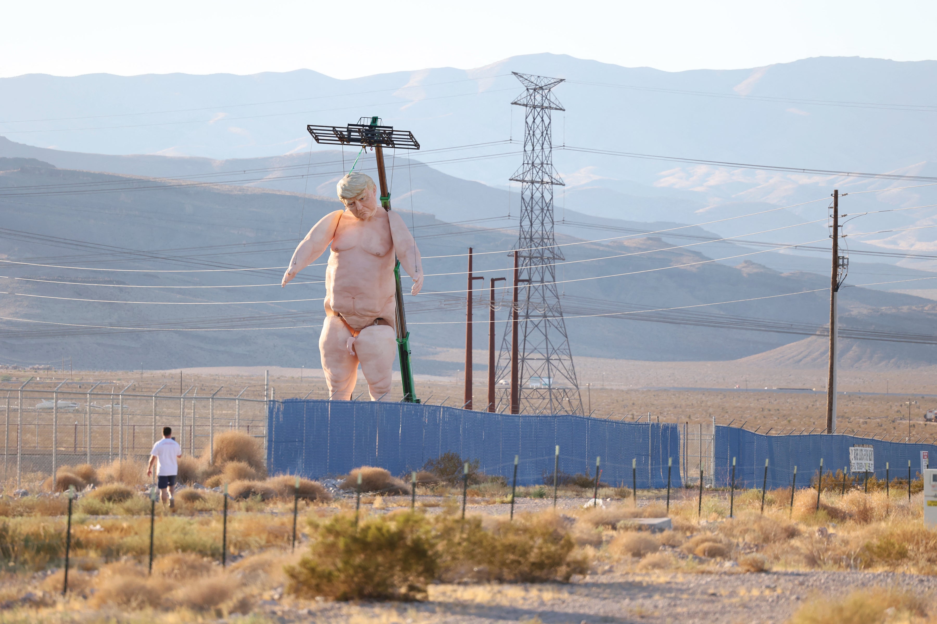 A 43-foot-tall naked statue resembling former US President and Republican presidential candidate Donald Trump is displayed in a fenced-in lot near Interstate 15 north of Las Vegas, Nevada, on September 28