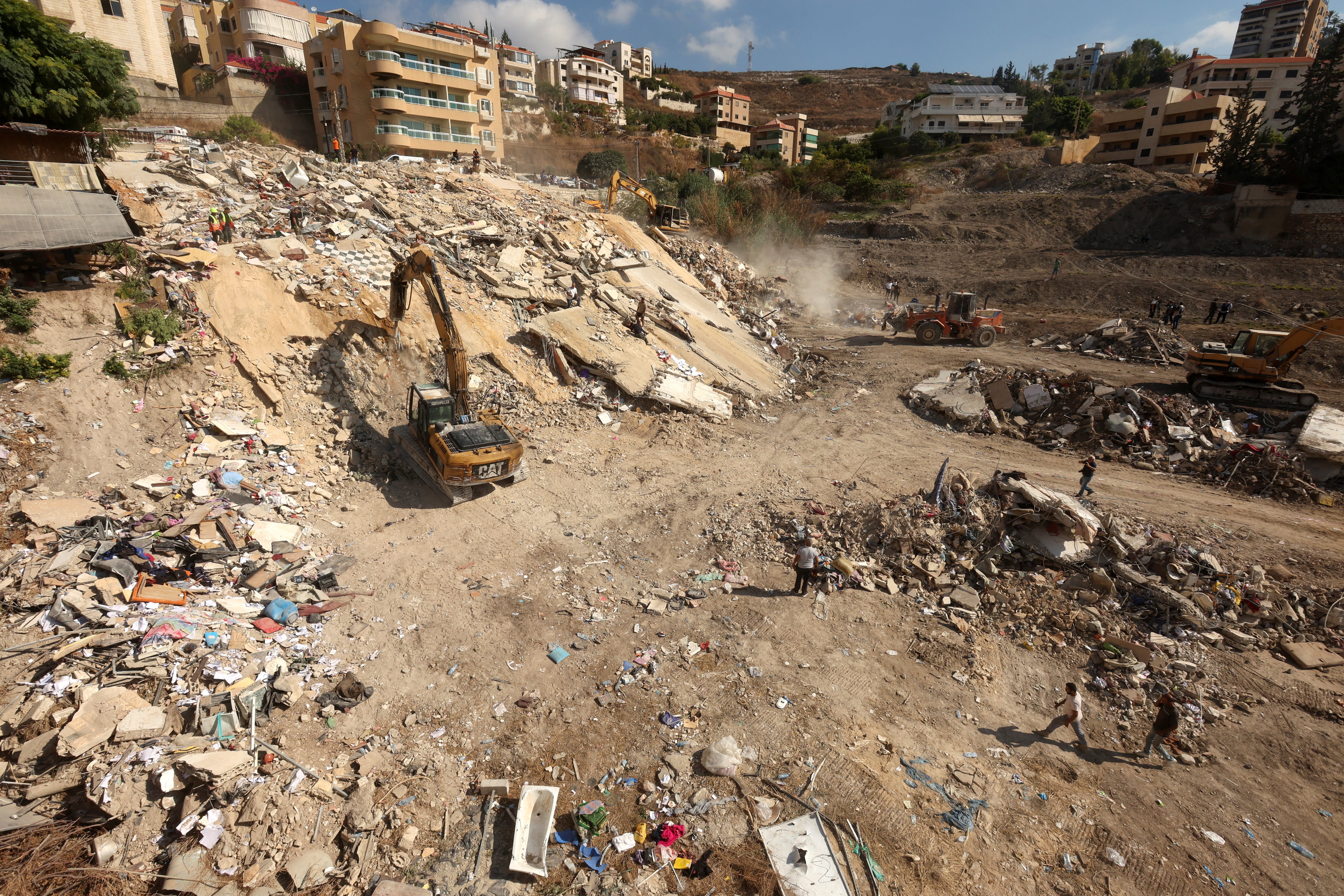 Rescuers work at the site of Sunday's Israeli attack on the city of Ain Deleb, amid the ongoing hostilities between Hezbollah and Israeli forces, in southern Lebanon