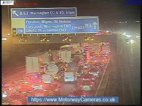 Motorway traffic camera capturing the M6 closure at Junction 21 for Warrington