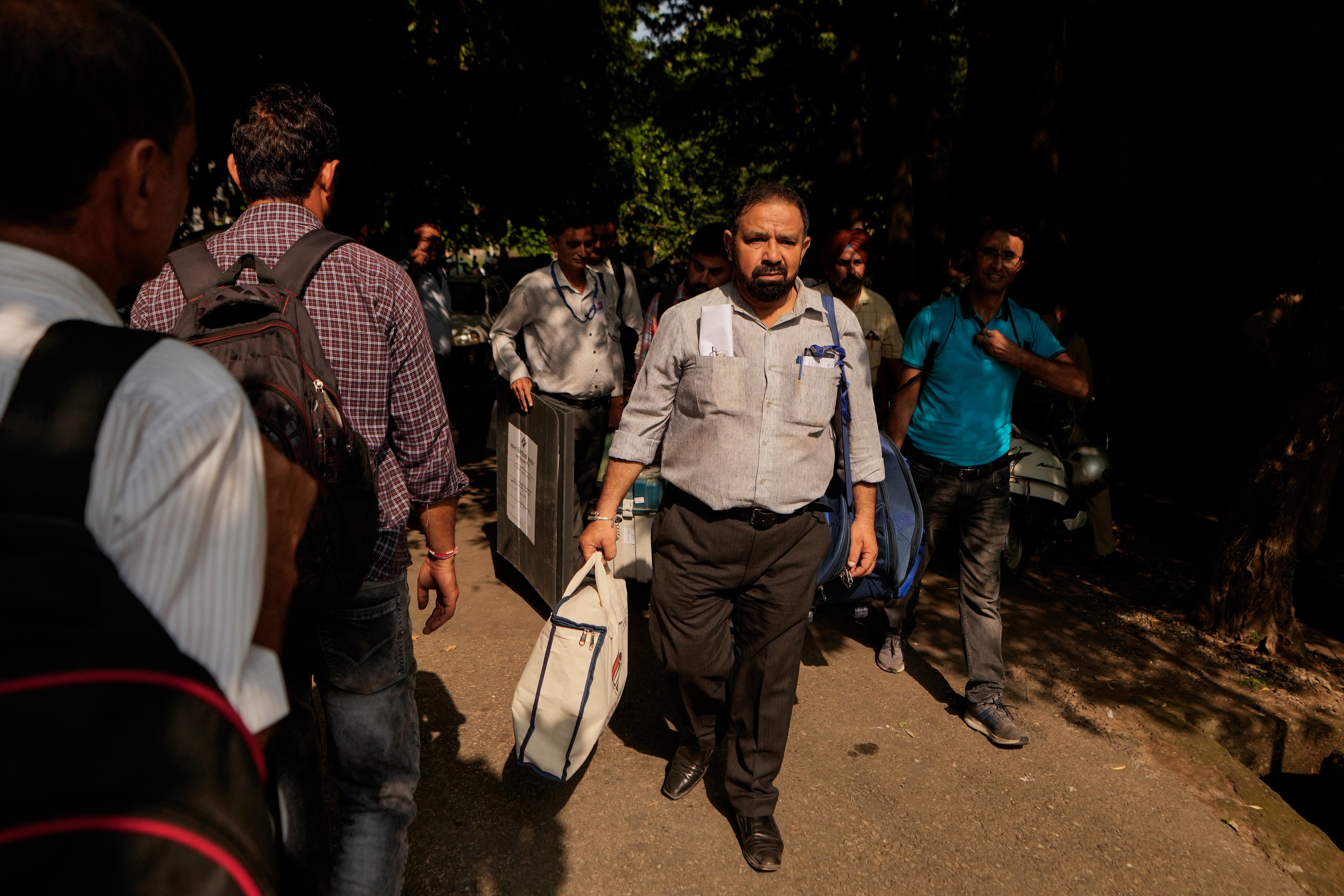 Polling officials leave with electronic voting machines and other election material on the eve of the third phase of the Jammu and Kashmir Assembly election, in Jammu, India, Monday, 30 Sept 2024