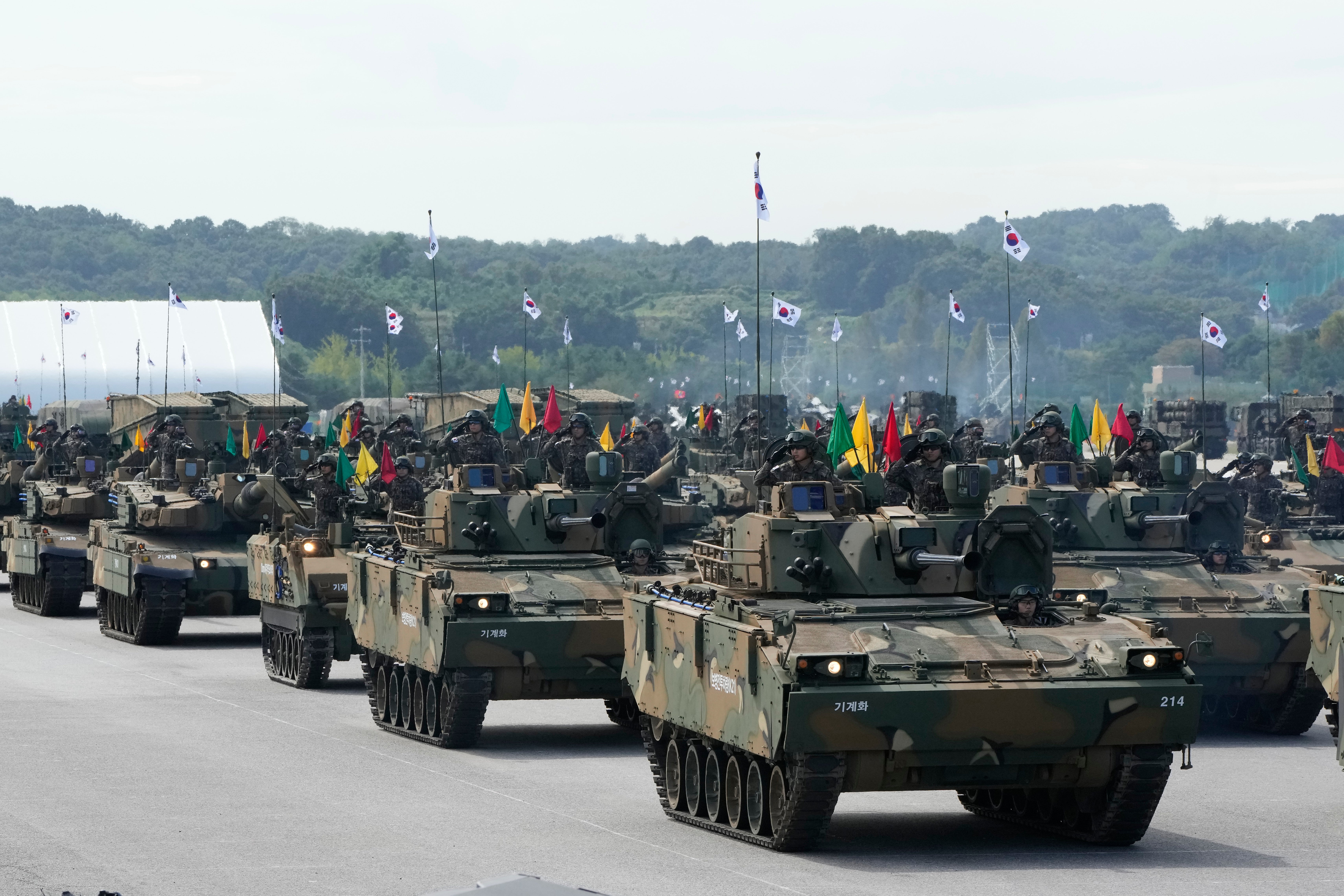 South Korean mechanized unit personnel parade with their armored vehicles during the media day for the 76th anniversary