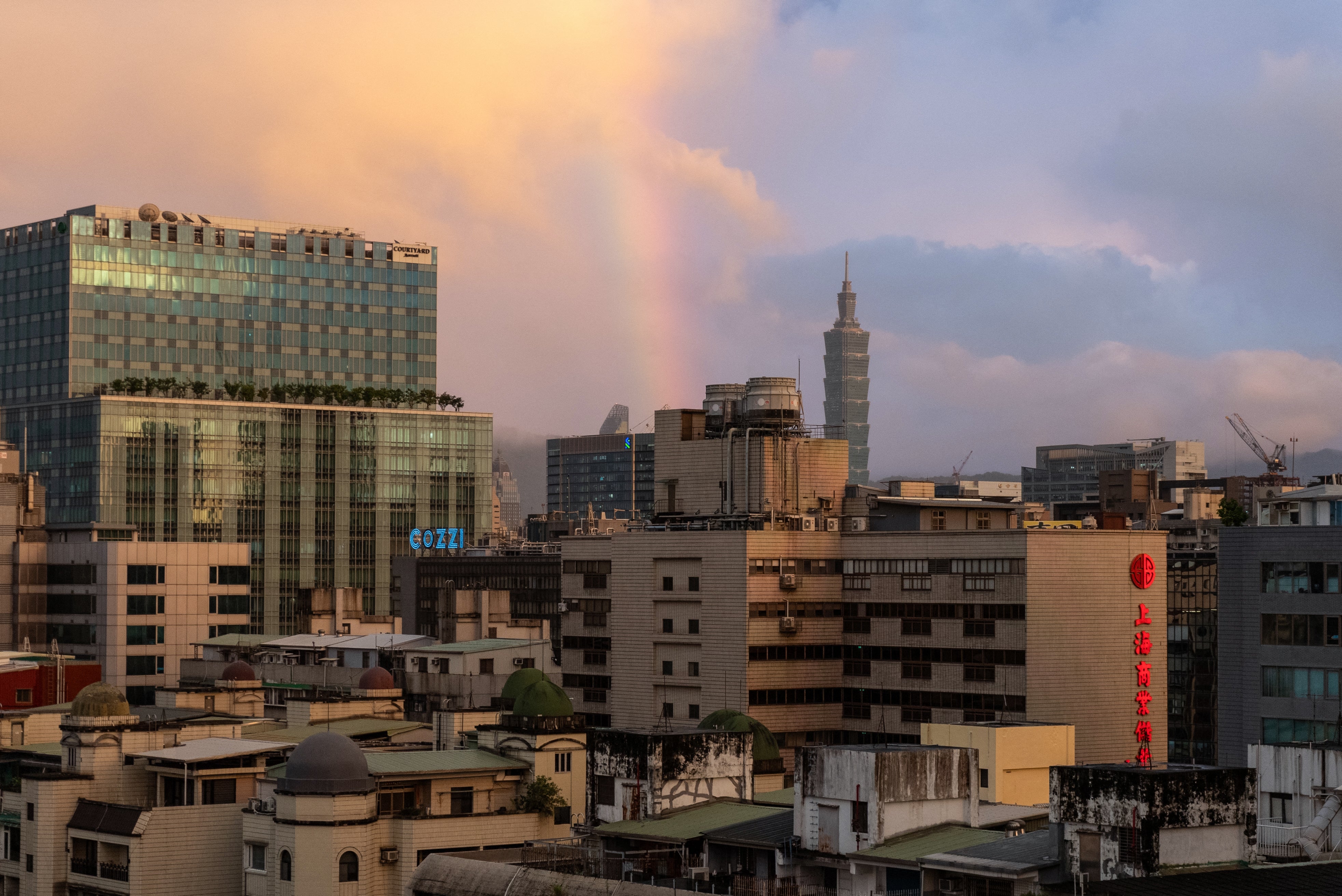 A rainbow is seen over the city of Taipei during sunset