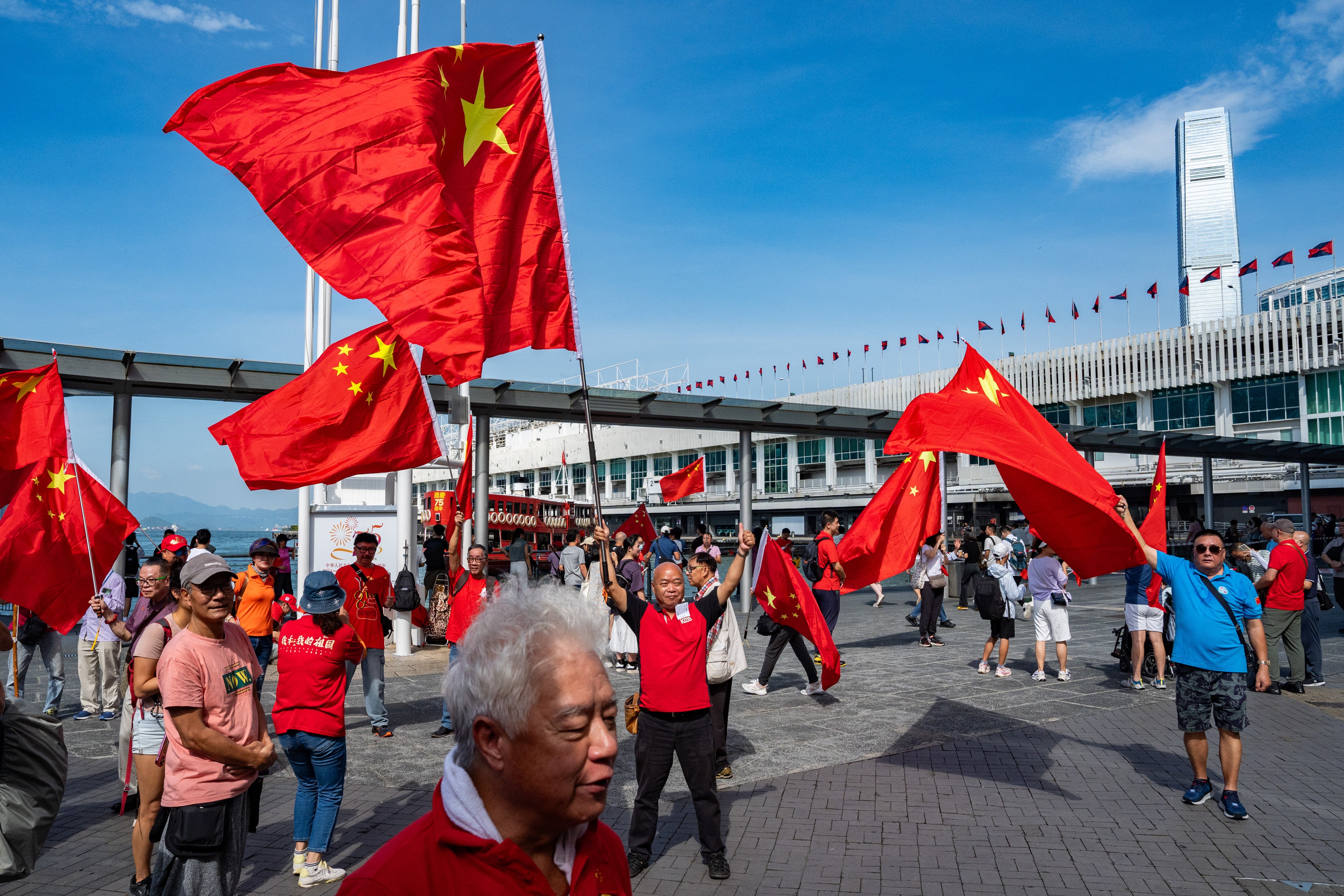 People wave Chinese flag to celebrate the 75th anniversary of China’s National Day in Hong Kong