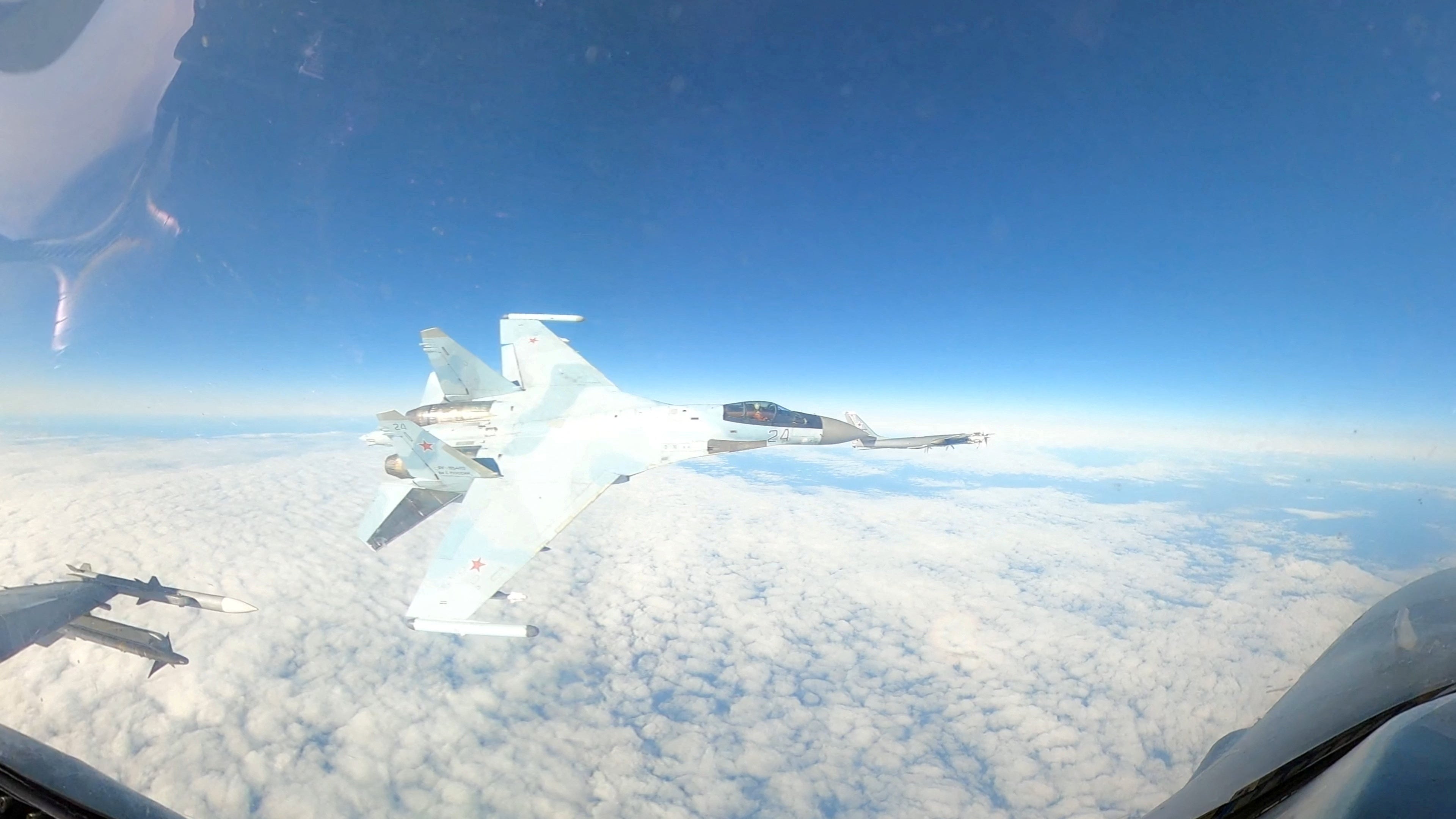 A Russian Su-35 flies next to a North American Aerospace Defence Command aircraft, an F-16, in the Alaska air defence identification zone