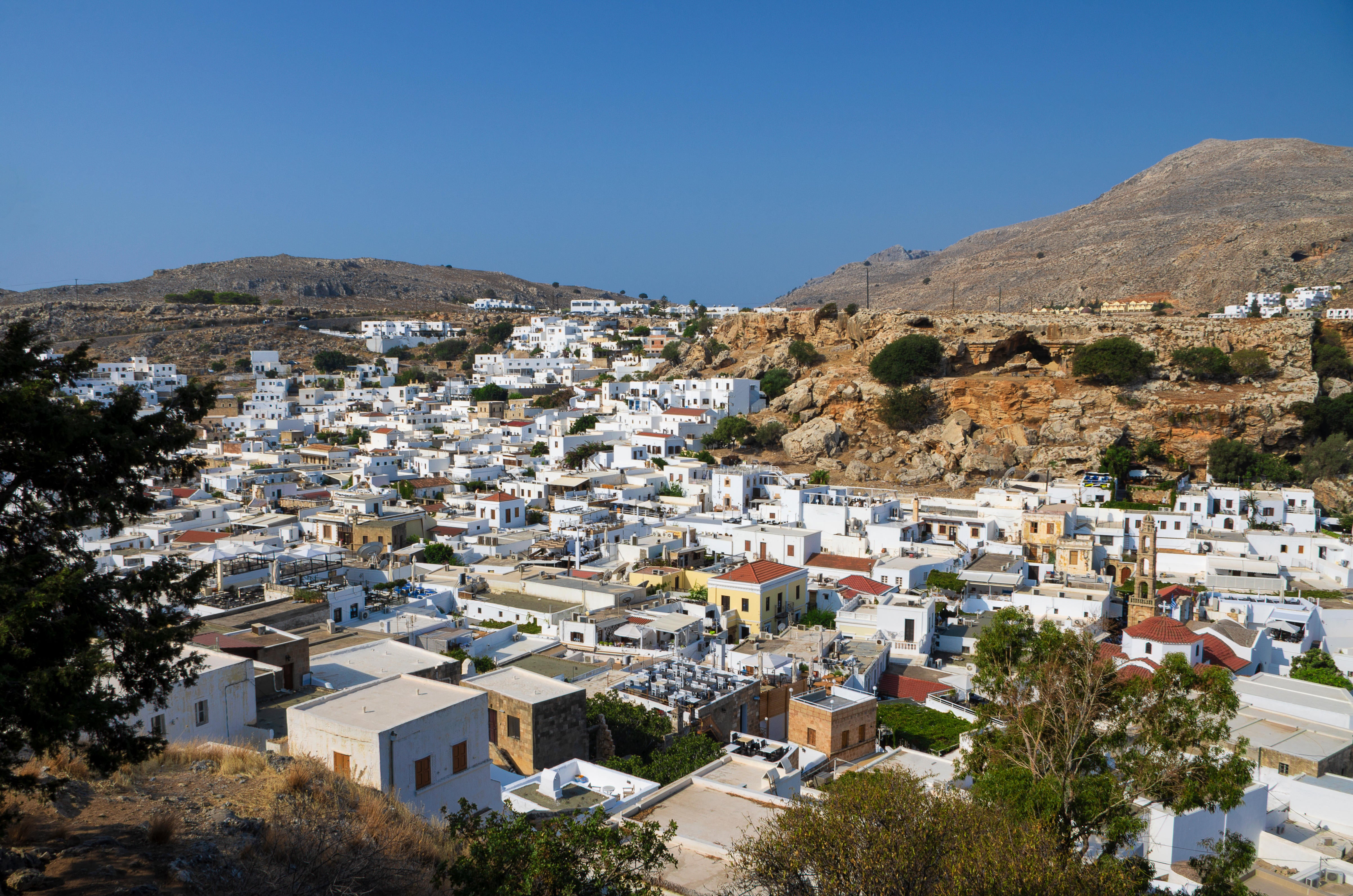 View of Lindos, Rhodes, Greece, with white roofs and blue sky