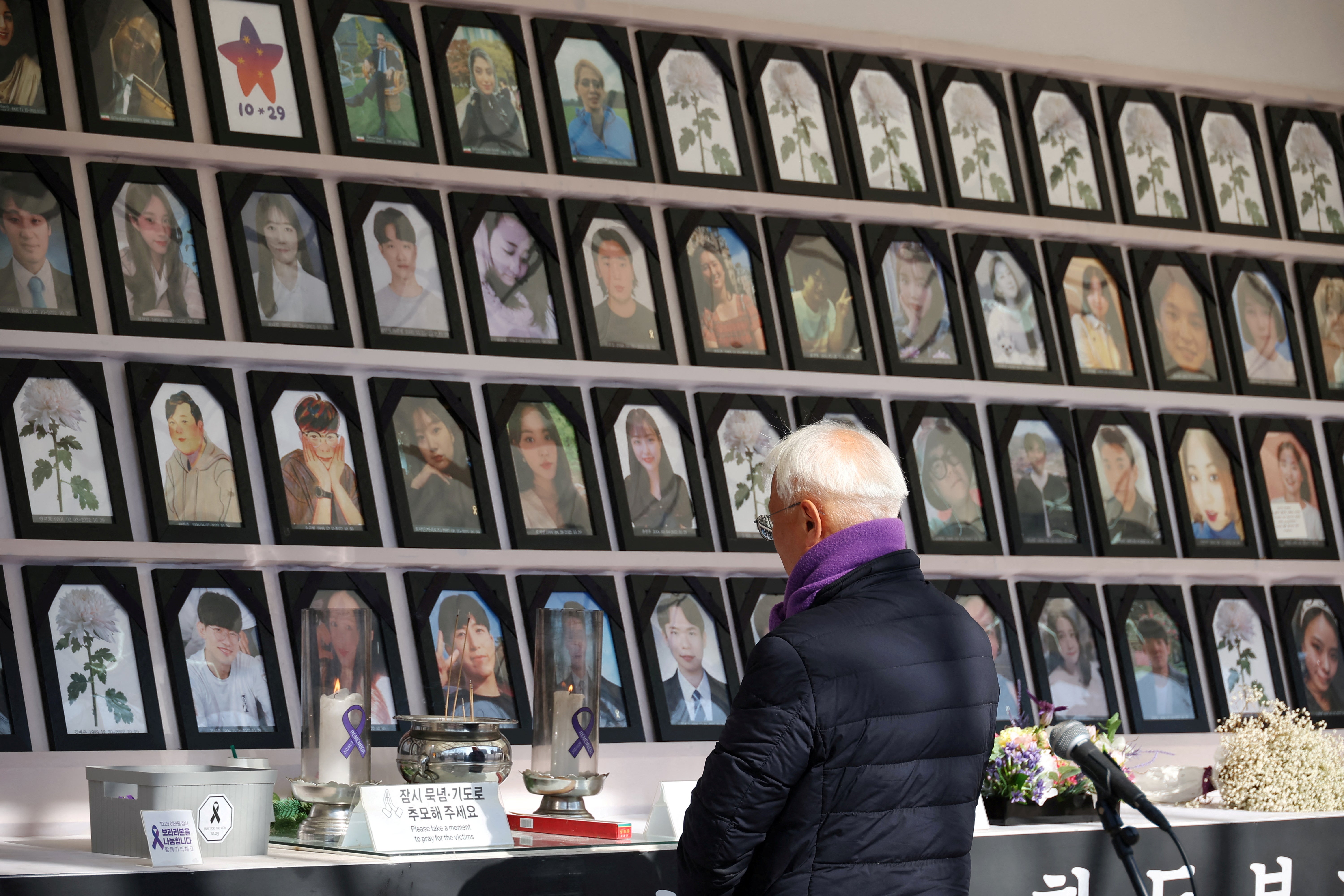 A man mourns at the memorial altar for victims of the Itaewon Halloween crowd crush that killed over 150 people in the party district of Itaewon, in Seoul, South Korea