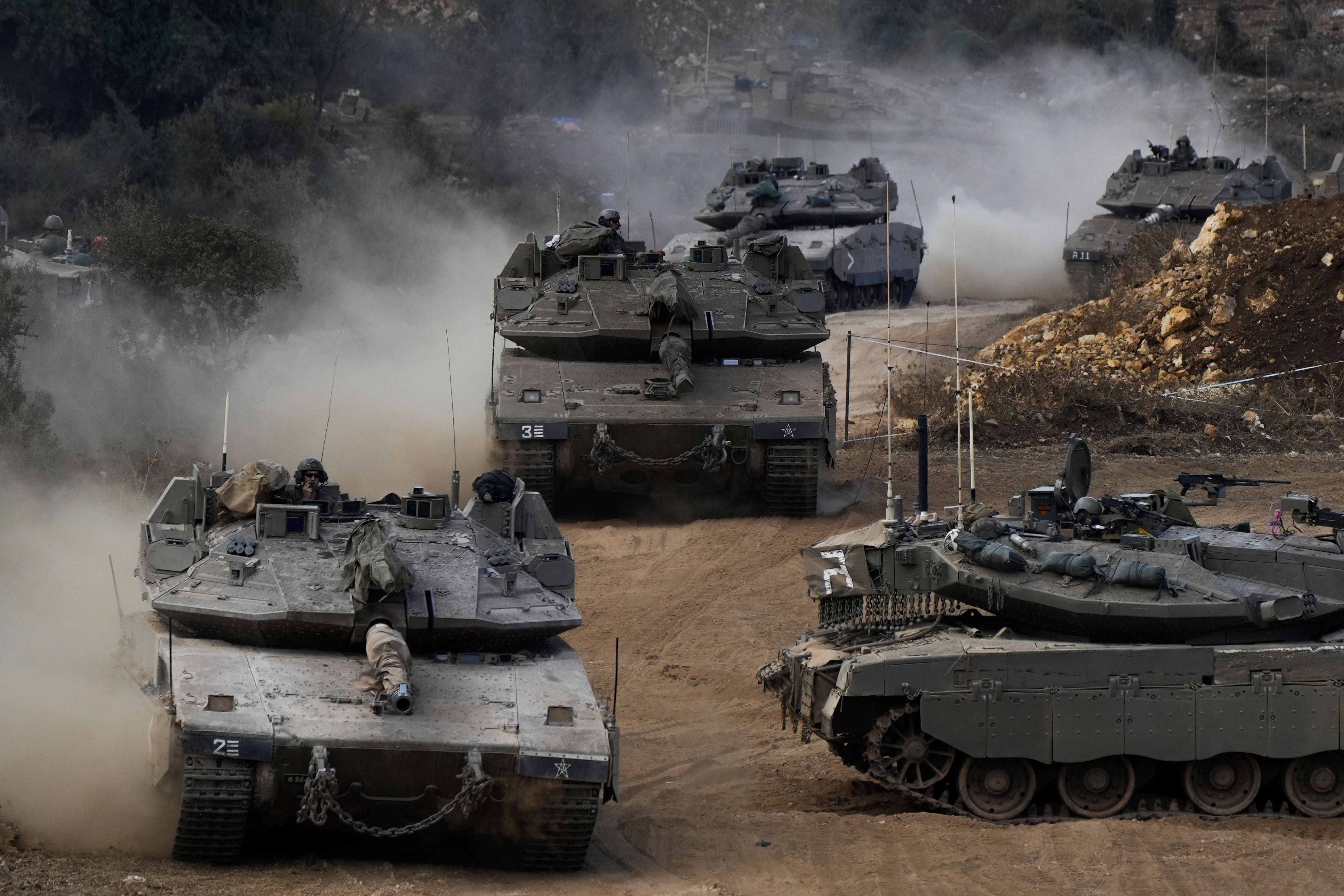 Israeli army tanks manoeuvre in a staging area in northern Israel near the Israel-Lebanon border (Baz Ratner/AP)