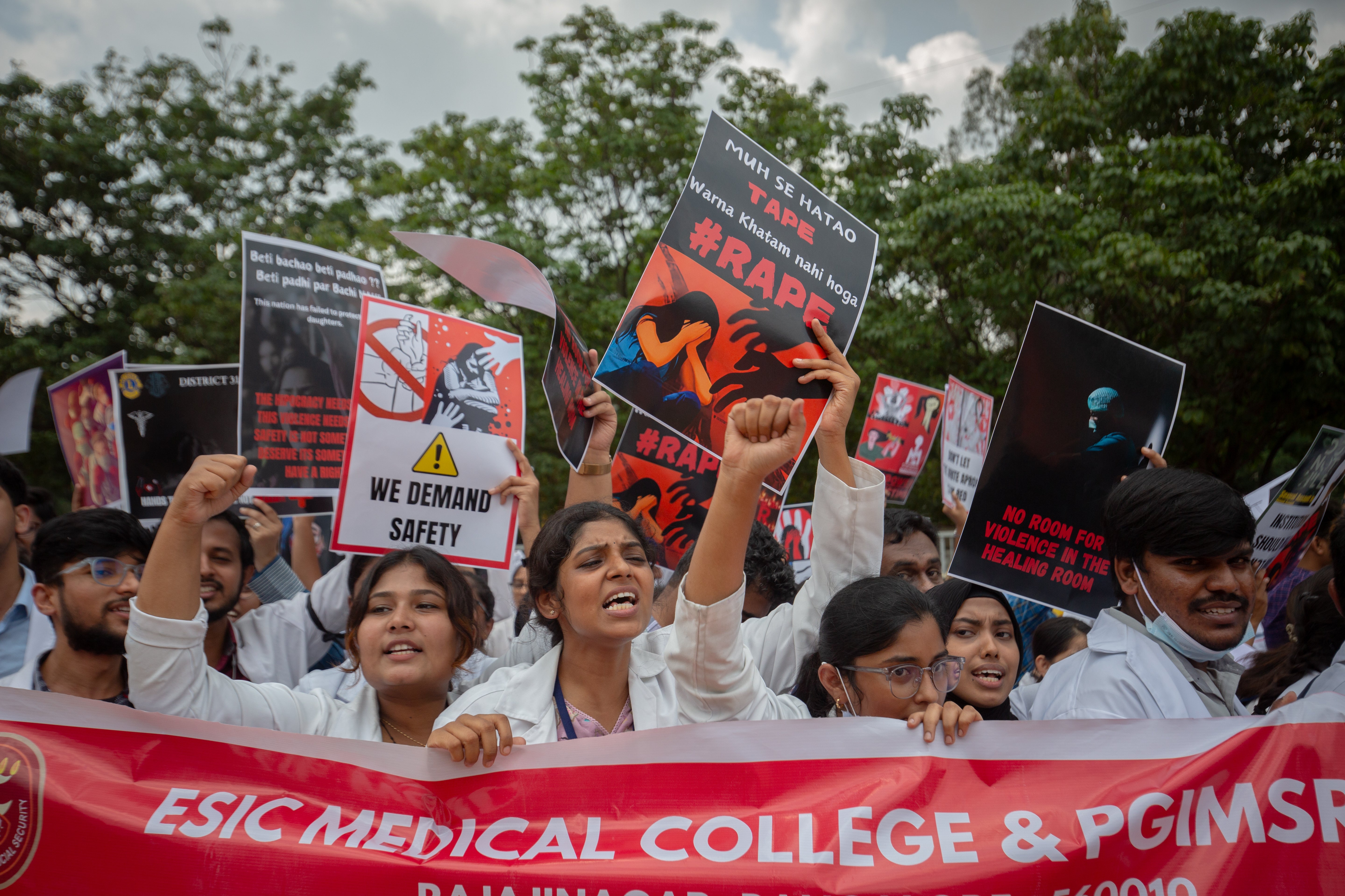 Doctors carry placards and shout slogans as they participate in a protest against the rape and murder of a doctor inside a hospital in Kolkata