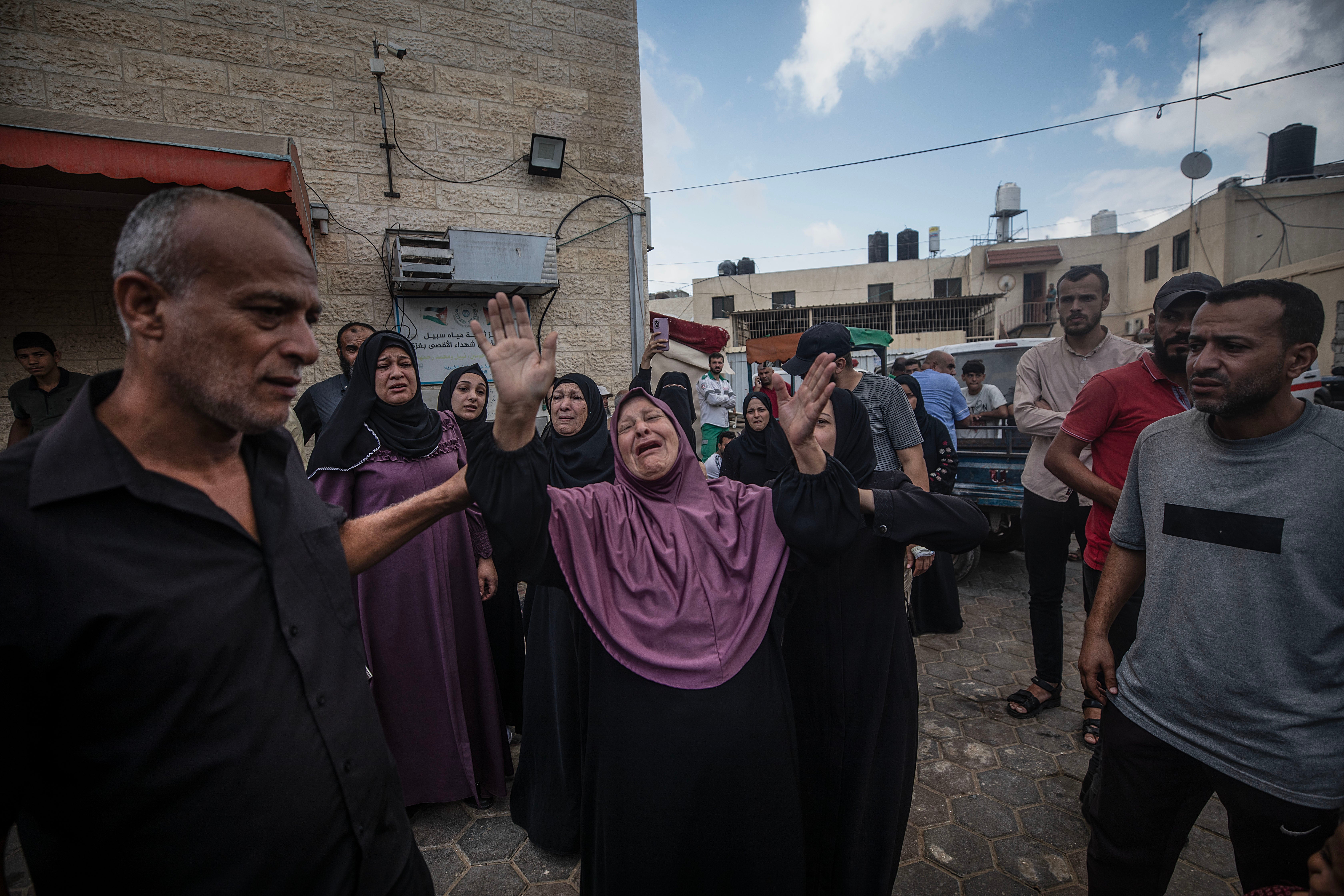 A woman reacts during the funeral of Al Dera family members following an Israeli air strike in Al Nusairat refugee camp, central Gaza Strip