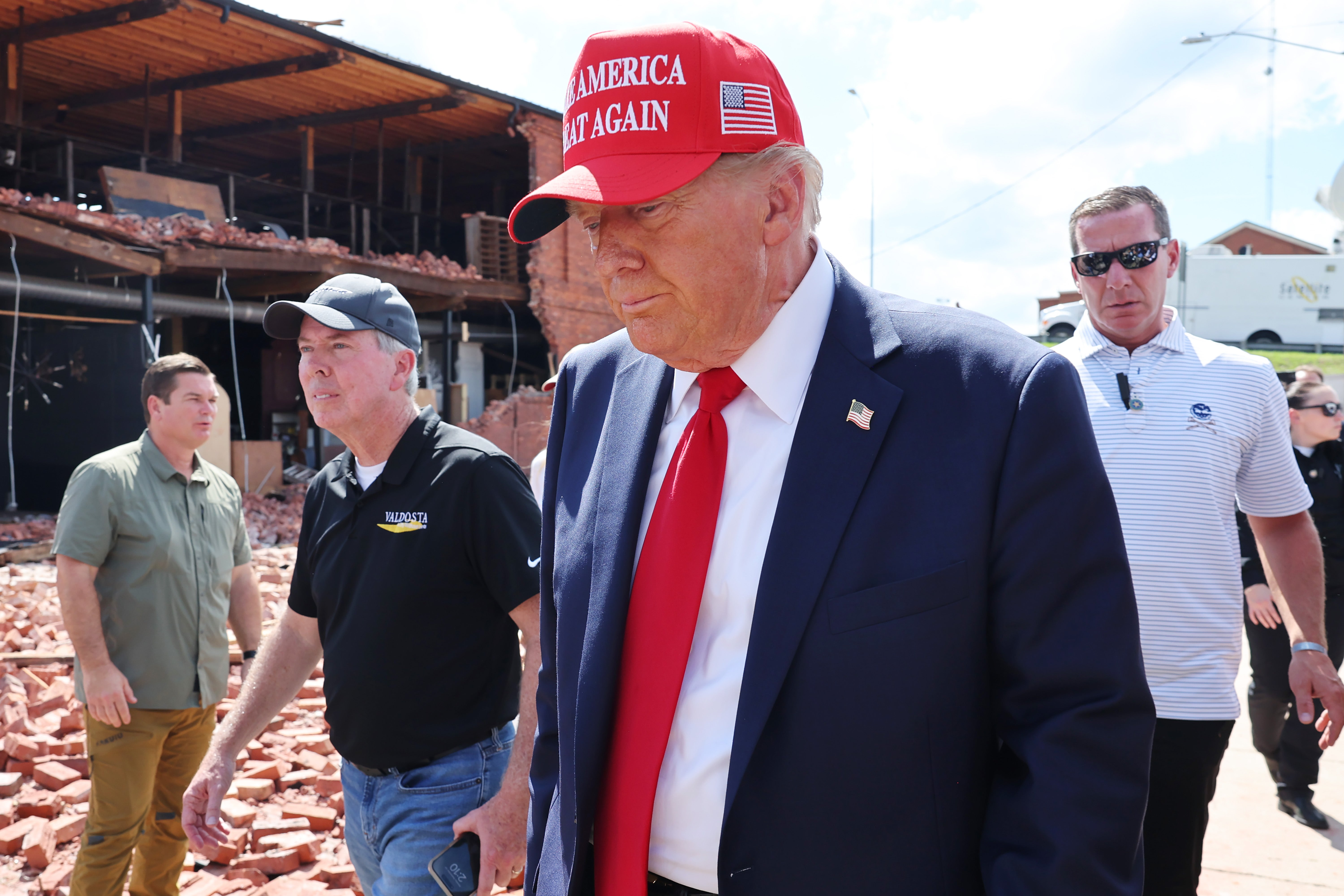 Donald Trump prepares to leave after visiting Chez What Furniture store that was damaged during Hurricane Helene on September 30, 2024 in Valdosta, Georgia. The former president launched a GoFundMe for those impacted by Hurricane Helene