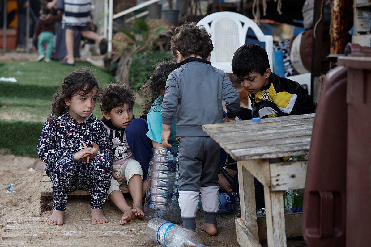 Displaced children play at an encampment on a beach in Beirut, where scores of residents have been driven to make shelter after strikes on the city