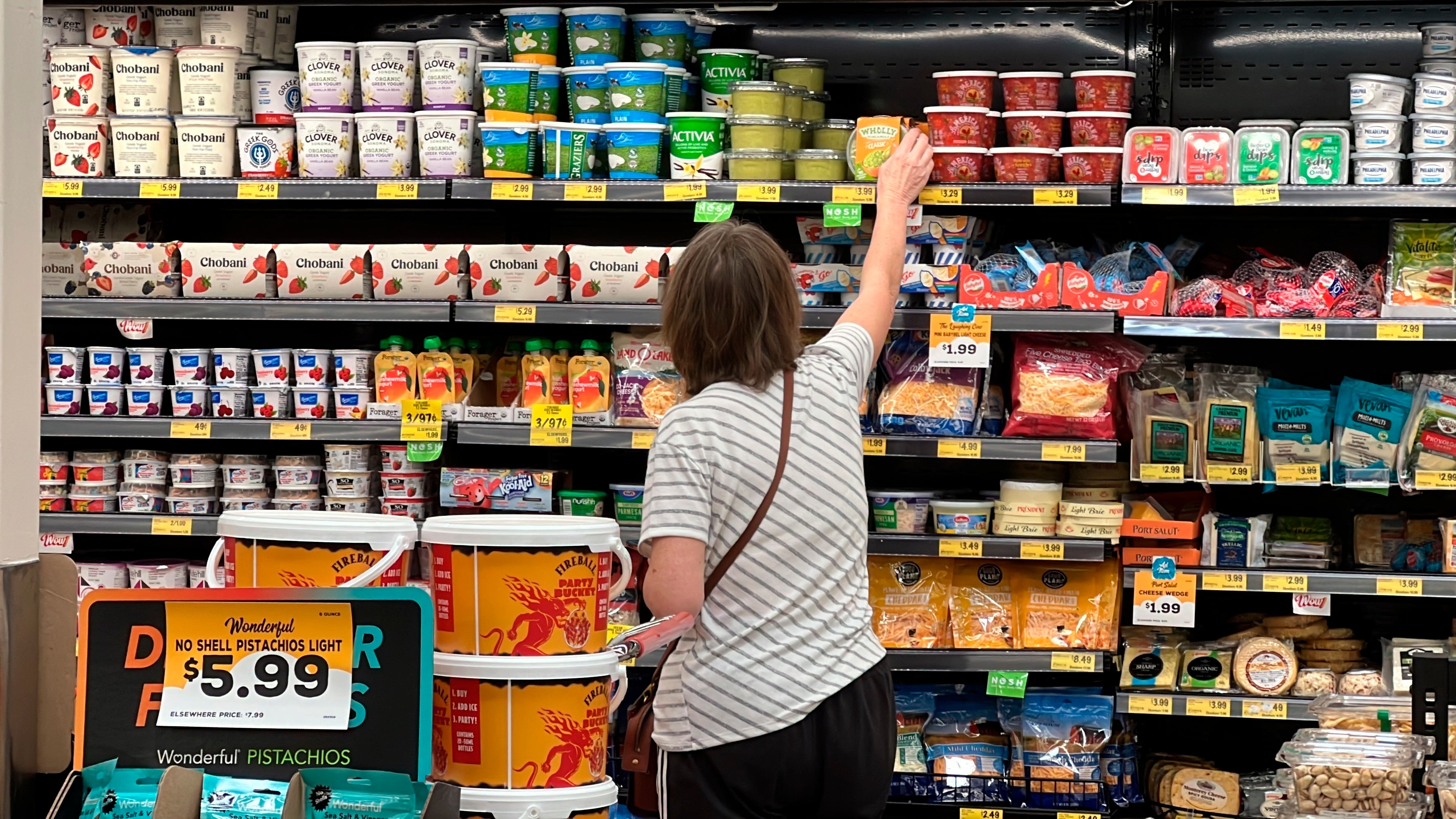 A customer looks at refrigerated items at a Grocery Outlet store in Pleasanton