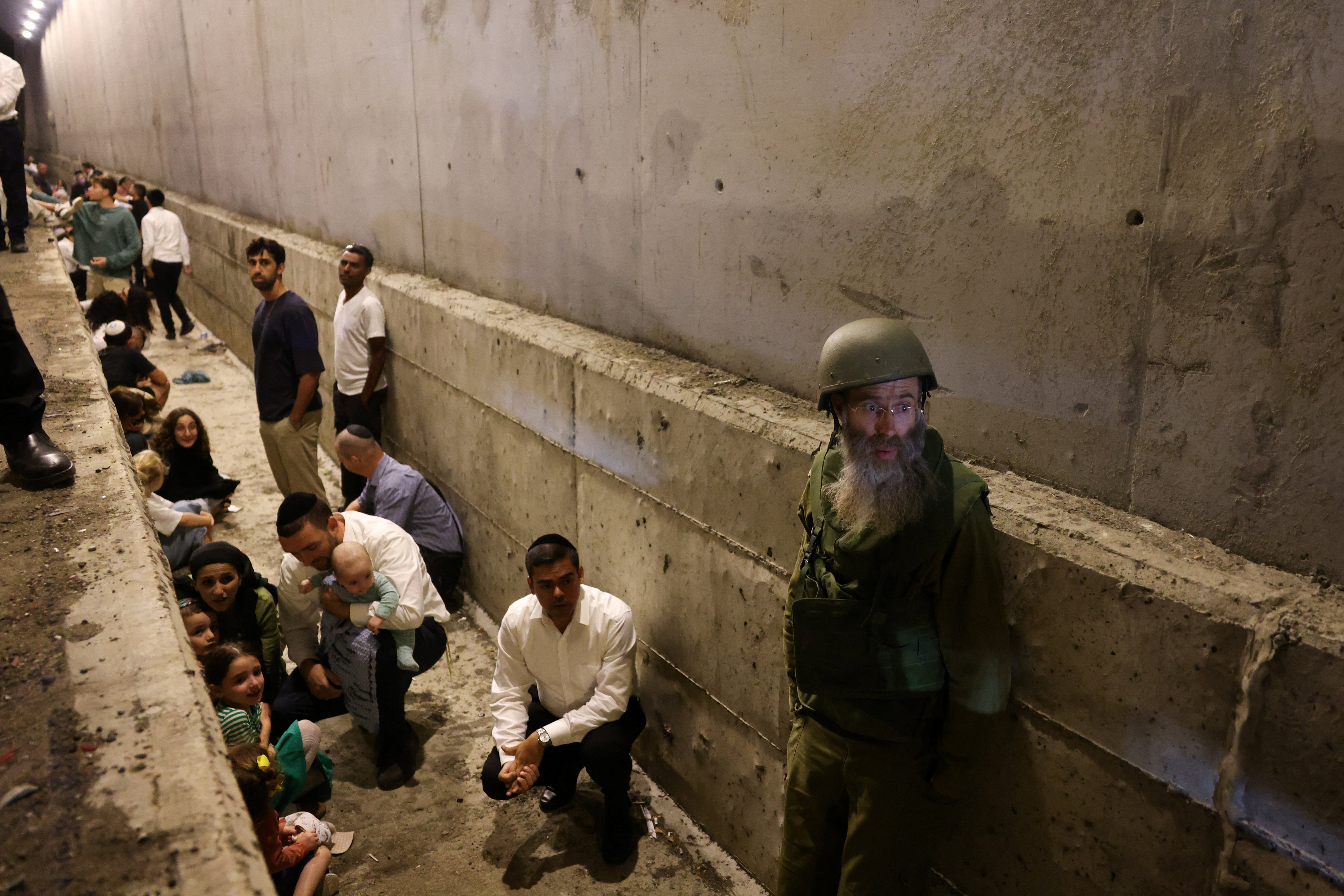 People take shelter after air raid sirens sounded in central Israel