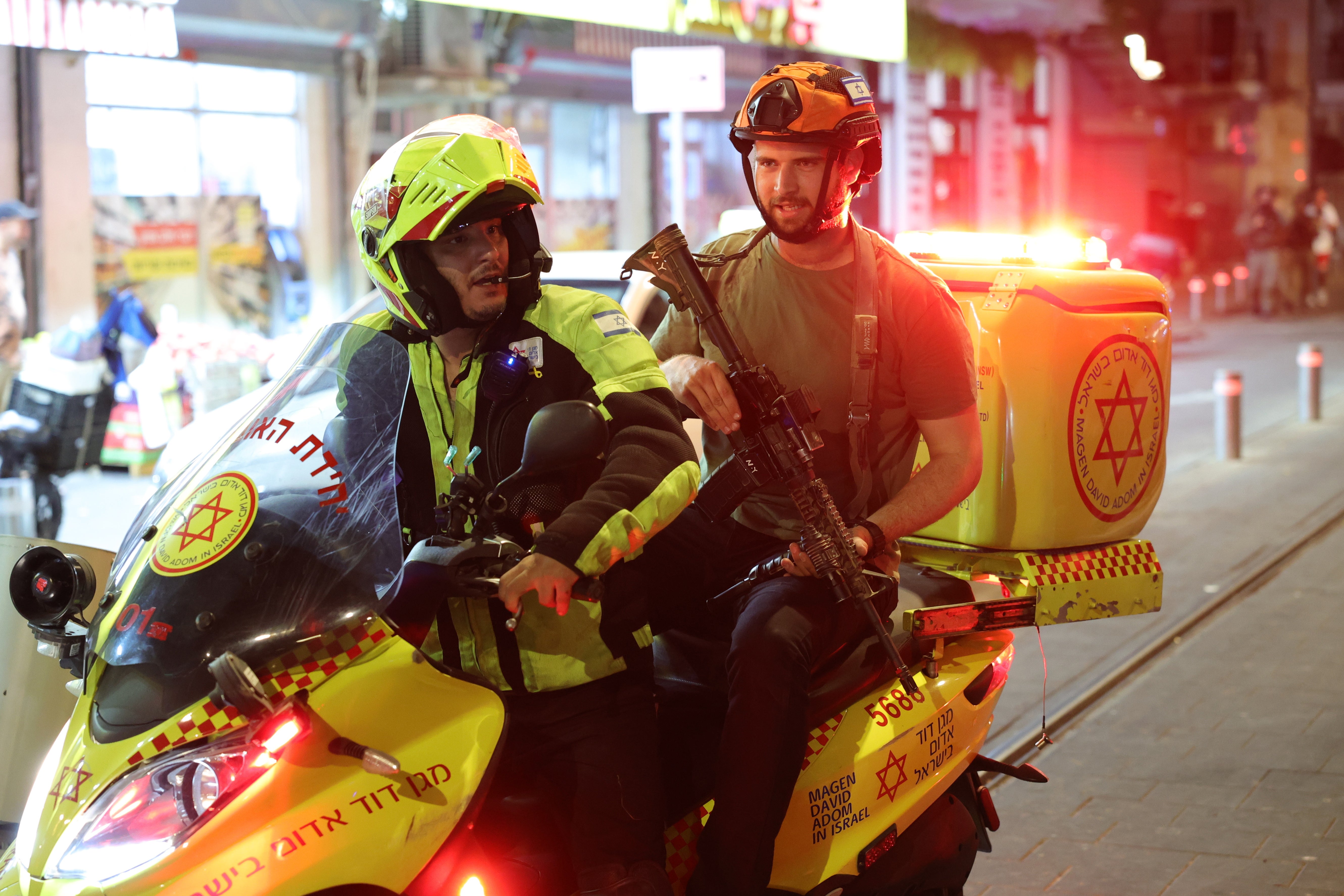 Israeli medical services and security personnel on a motorbike at the site of the shooting incident