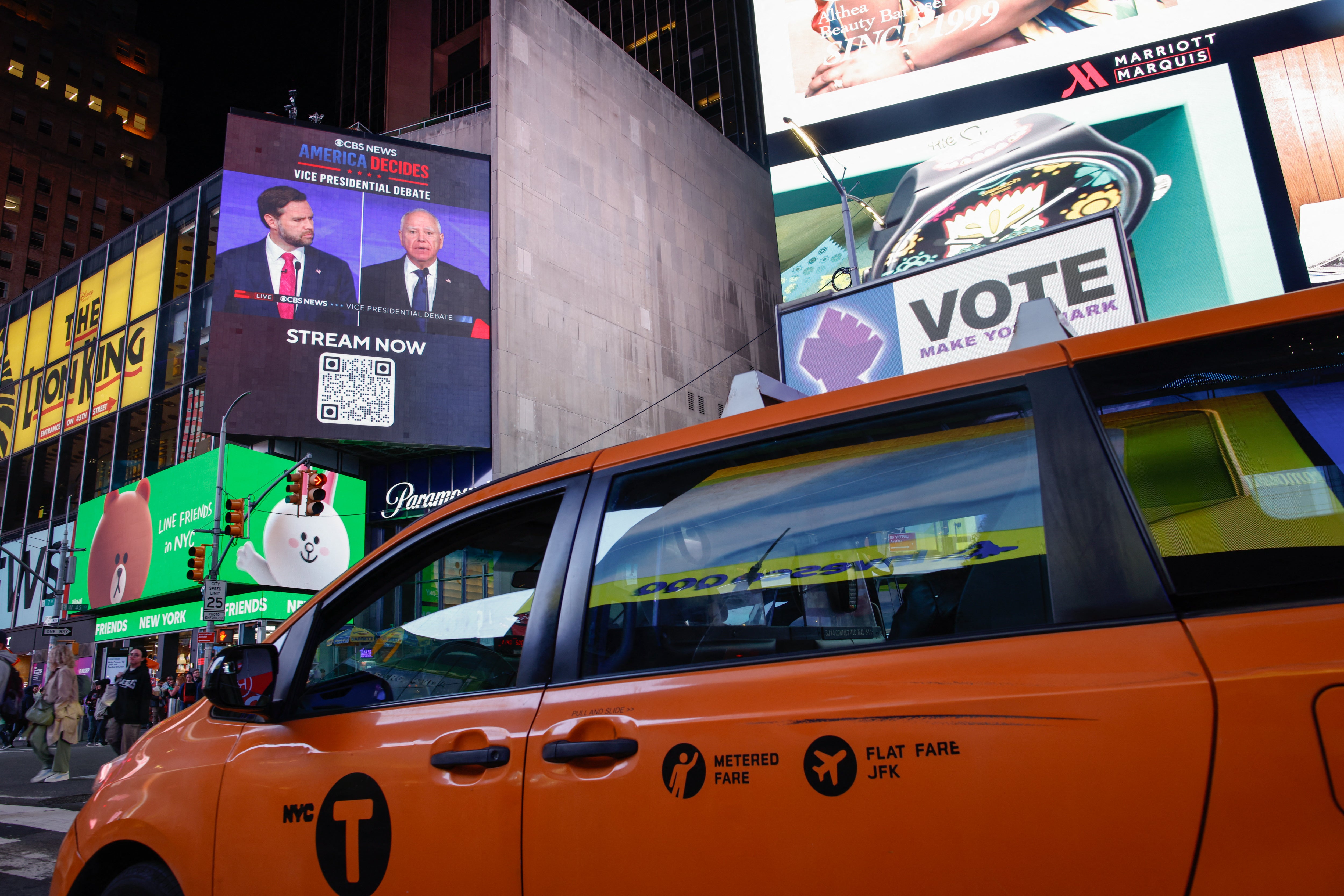 A screen in New York’s Times Square shows the debate between JD Vance and Tim Walz