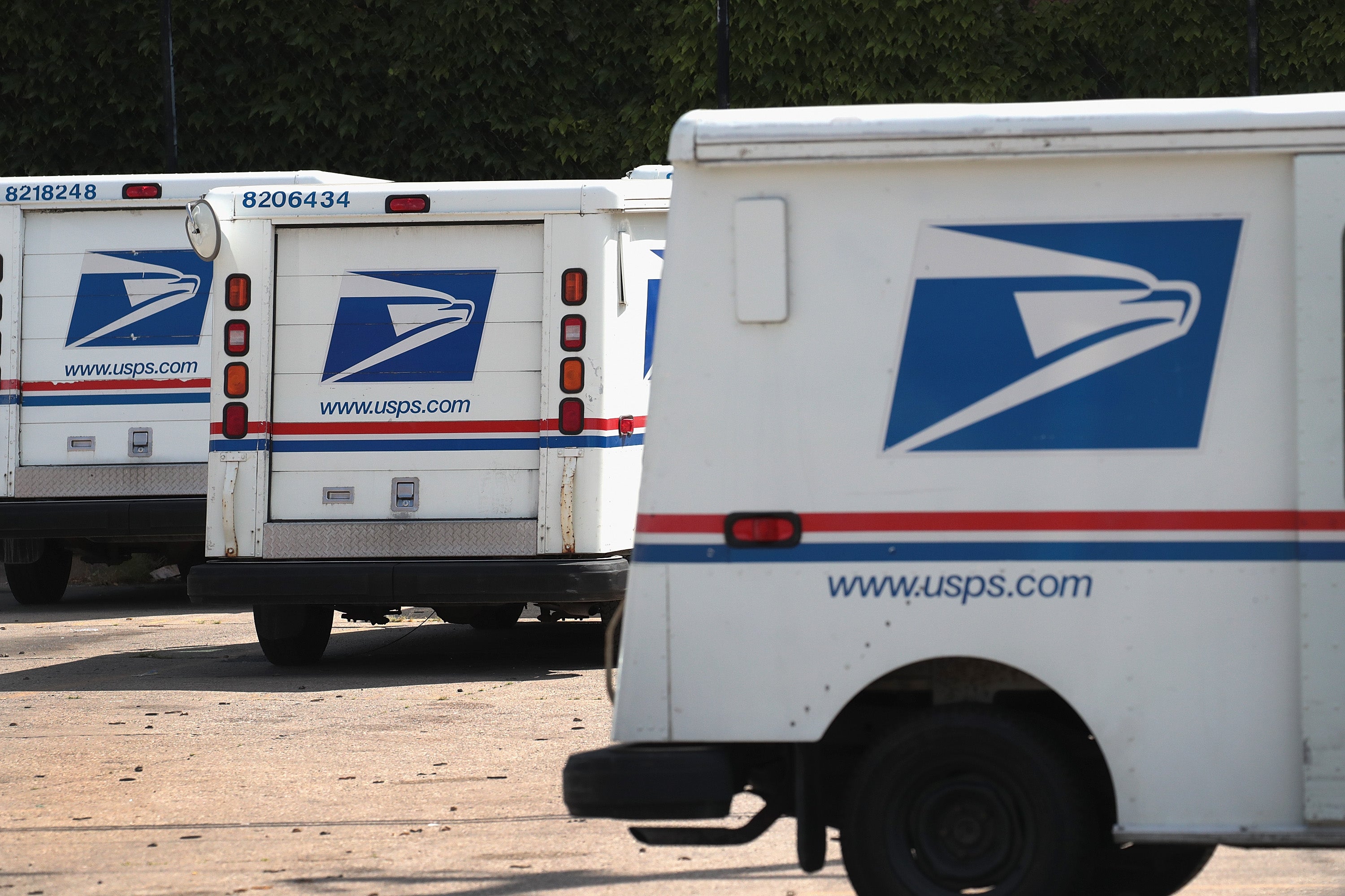 Chicago police and US Marshals arrested murder suspect in Cedar Rapids, Iowa, on September 30. Postal Service vans in Chicago are pictured