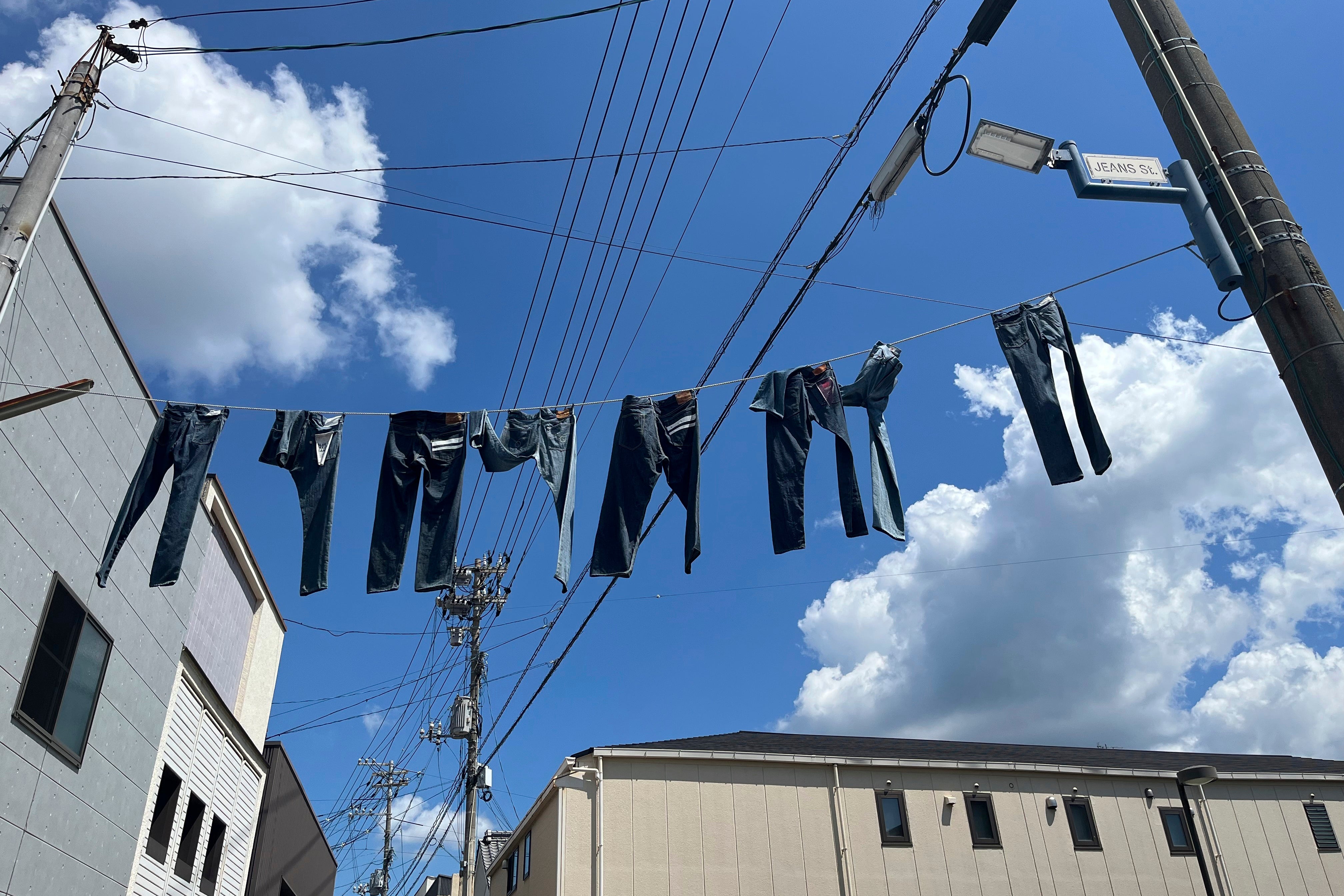 Pairs of jeans flap over Jeans Street in Kojima, Okayama prefecture, Japan