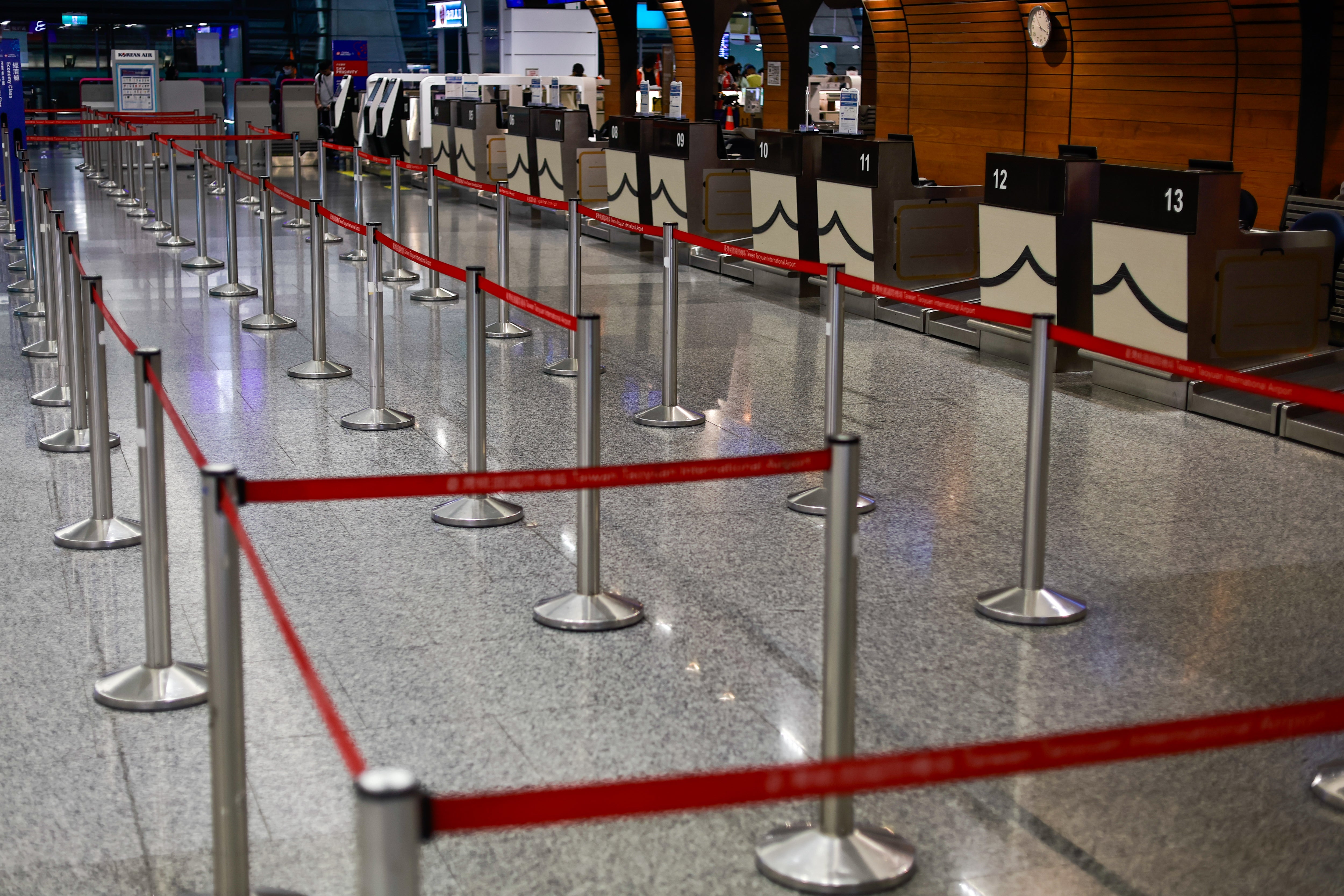 Empty check-in counters are seen at Taoyuan International Airport