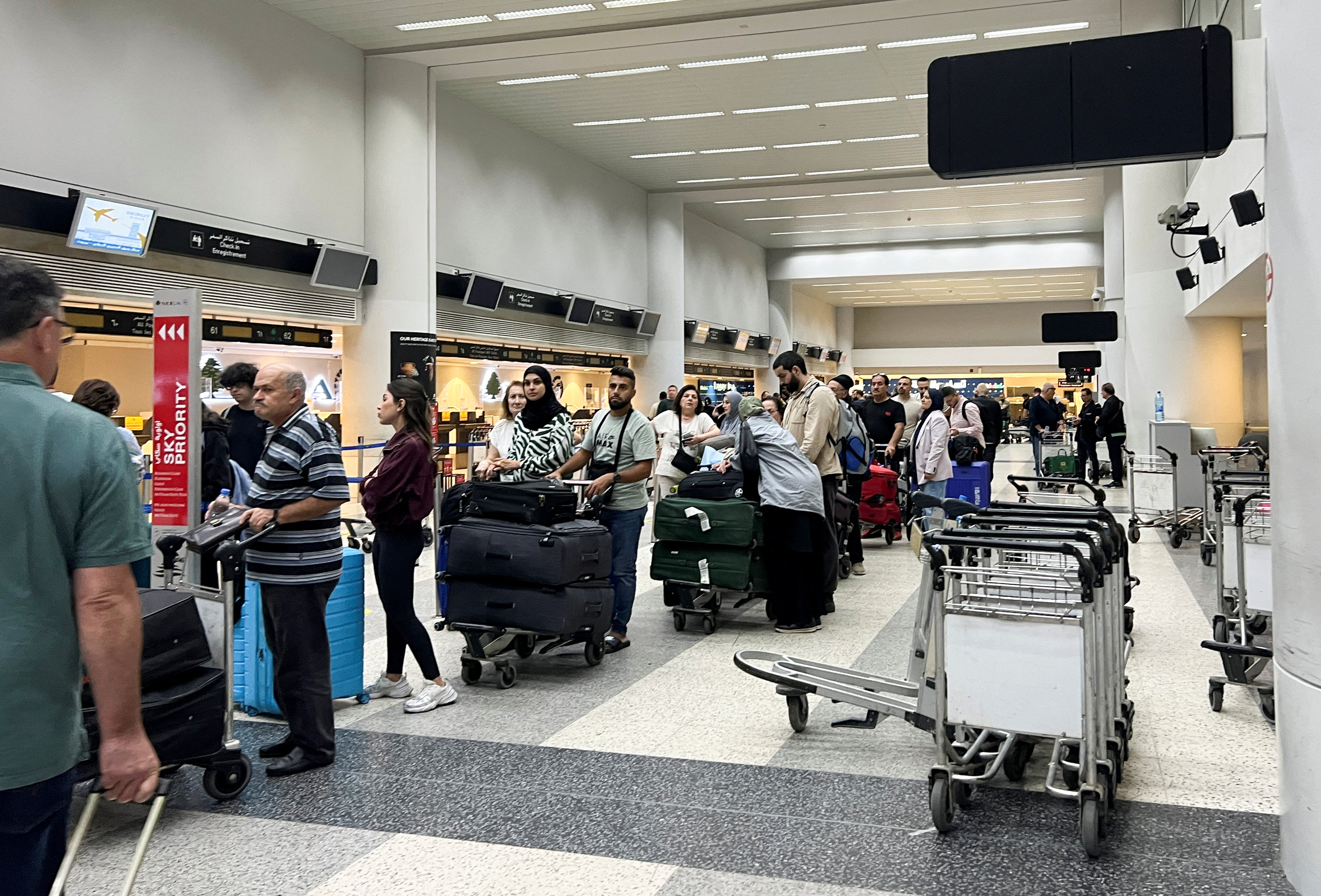 Passengers queue at the check-in counters at Beirut-Rafic Al Hariri International Airport, in Beirut, Lebanon