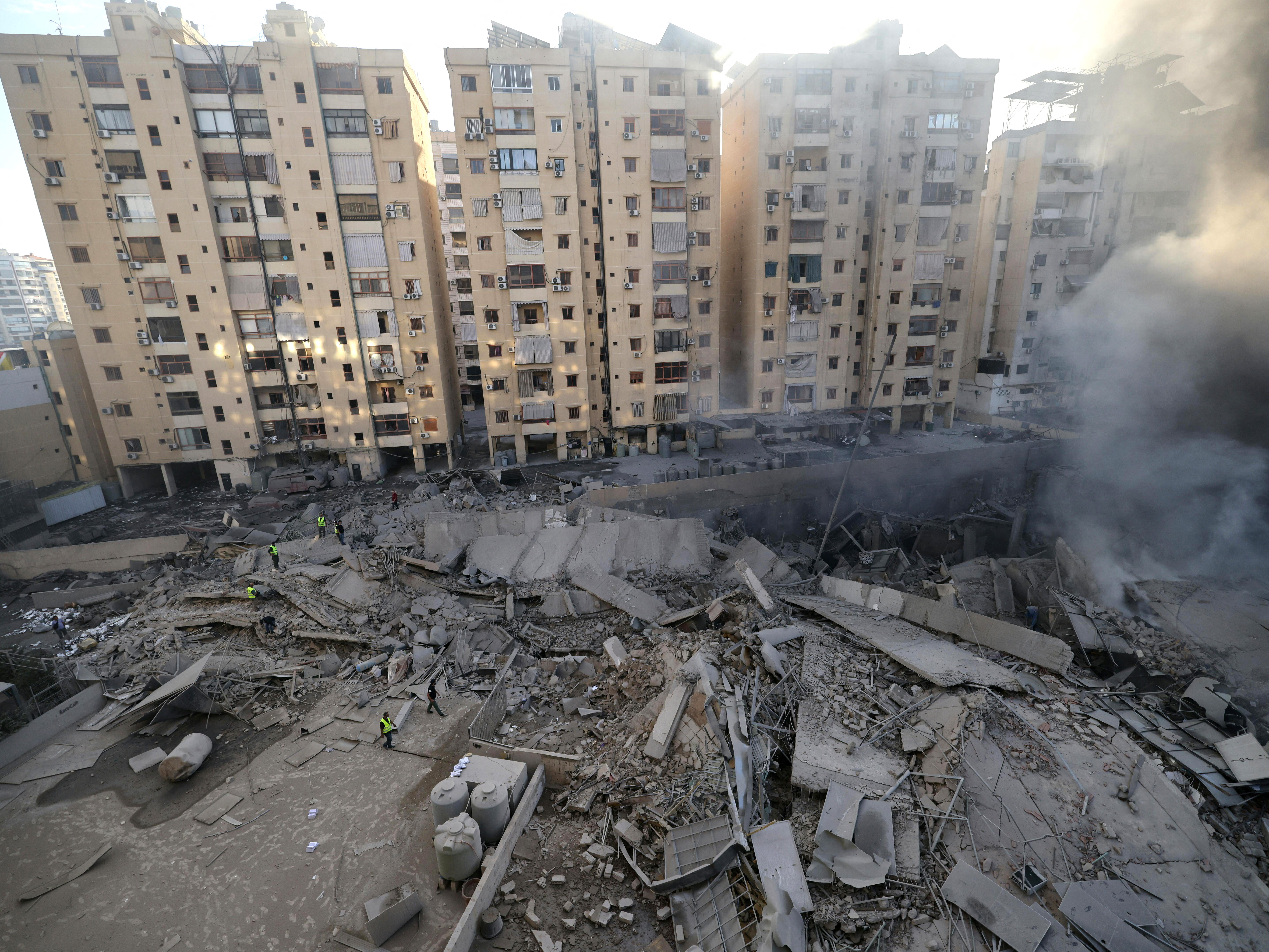 Dust and smoke billow from the site of an overnight Israeli airstrike in Beirut's southern suburb of Shayyah