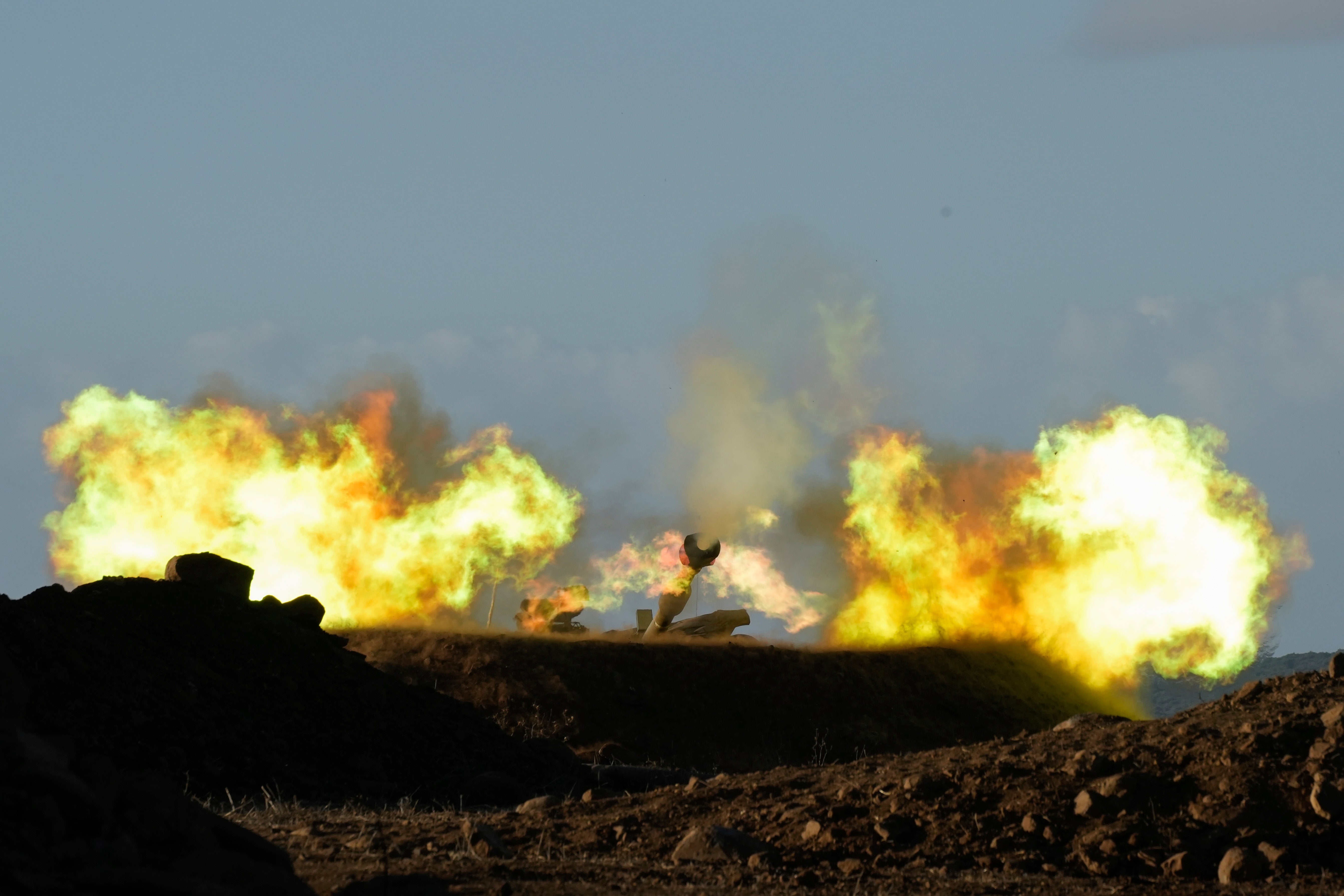 An Israeli mobile artillery unit fires a shell from northern Israel towards Lebanon