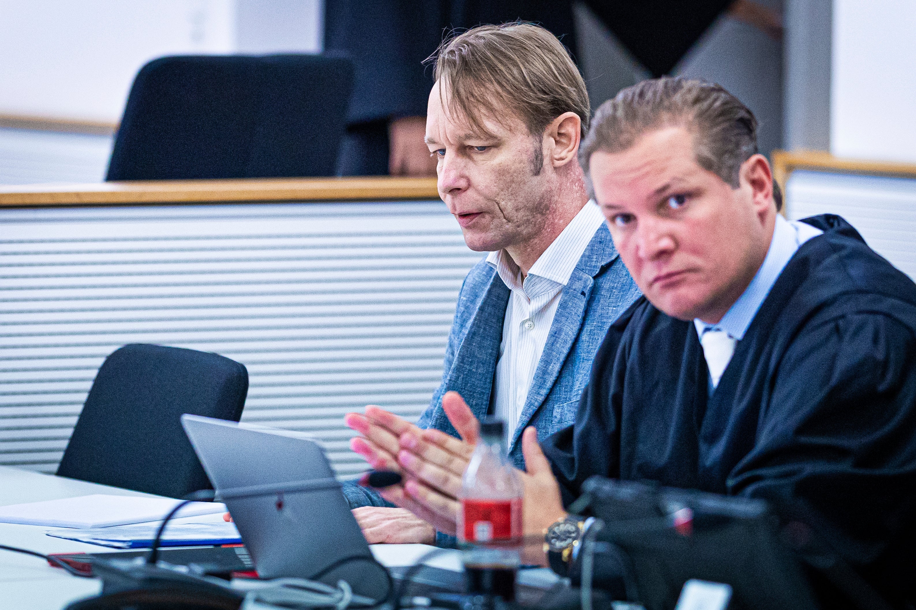 The defendant Christian B., left, accused of three cases of aggravated rape and two cases of sexual abuse of children in Portugal, sits next to his defense attorney Friedrich F'lscher in a courtroom in the district court in Brunswick, Germany, Wednesday Oct. 2, 2024