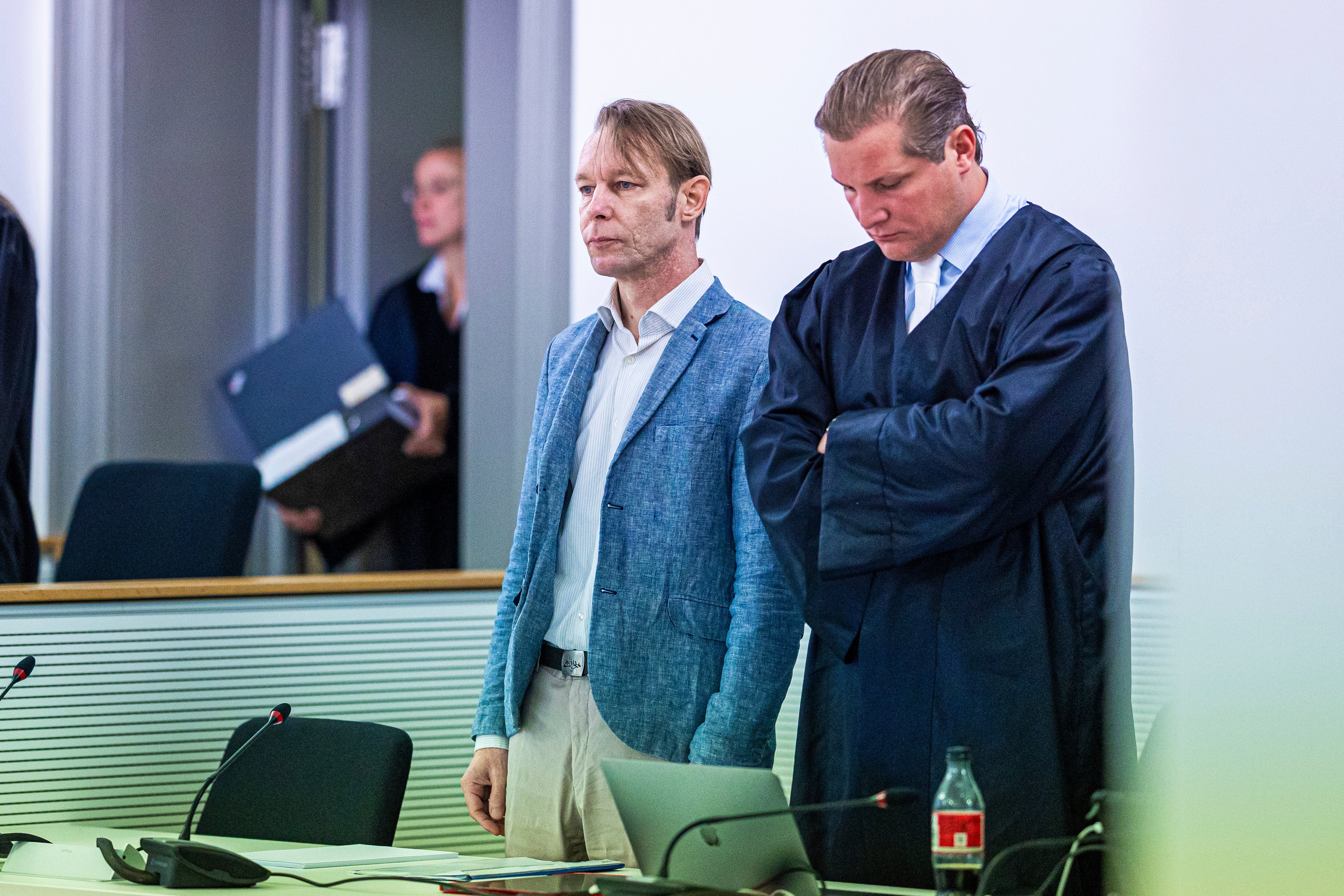 The defendant Christian B., left, accused of three cases of aggravated rape and two cases of sexual abuse of children in Portugal, stands next to his defense attorney Friedrich F'lscher in a courtroom in the district court in Brunswick, Germany