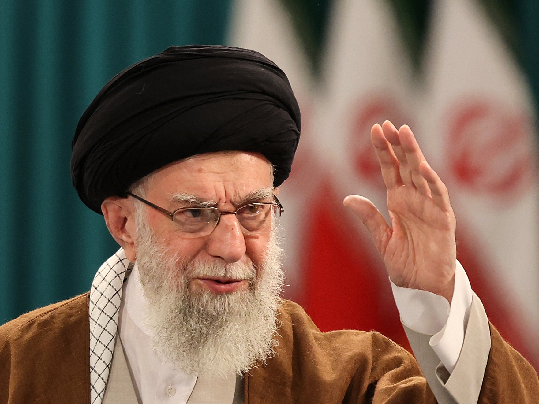 Ayatollah Ali Khamenei waves during a press conference in May