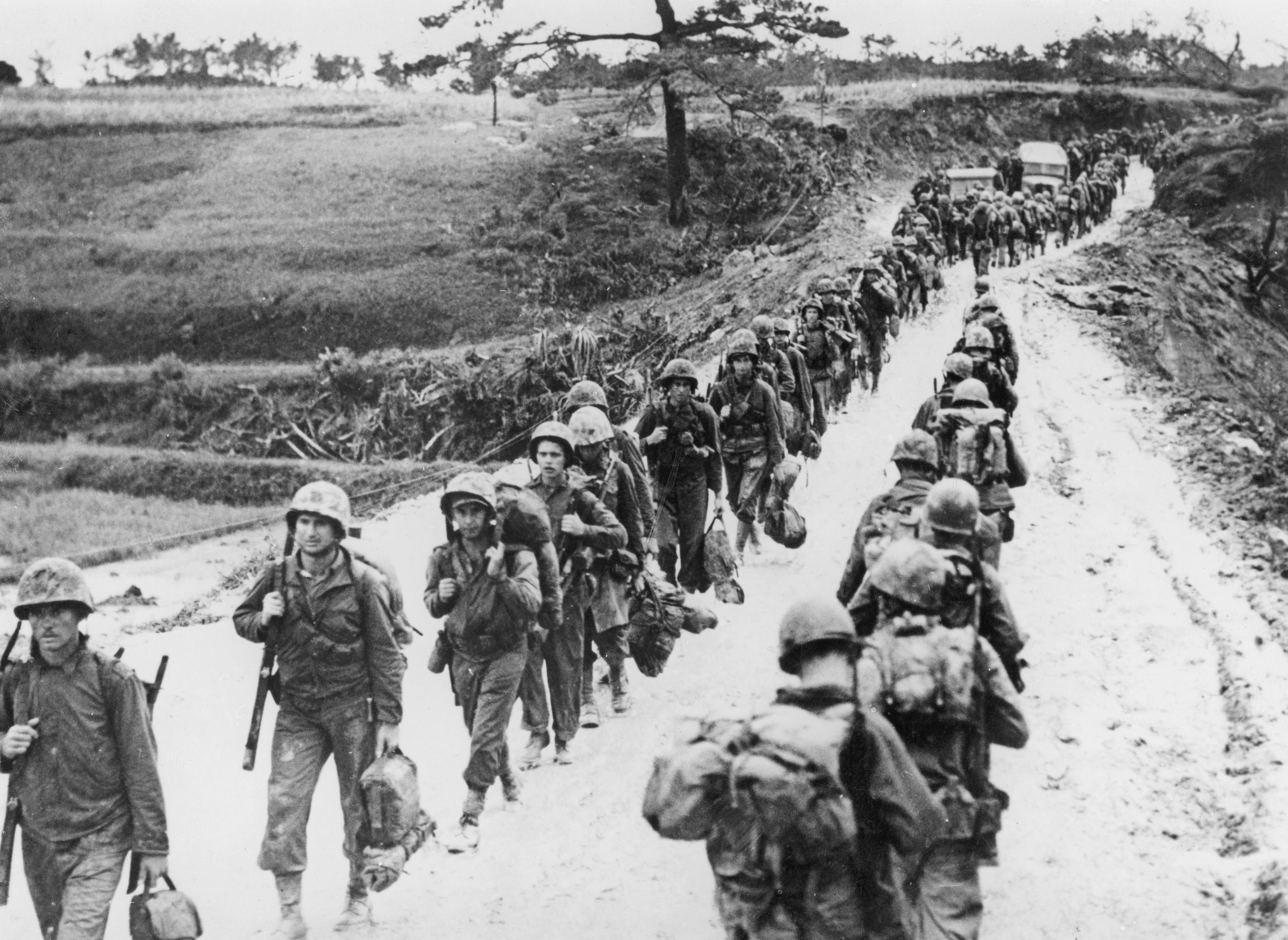 US Marines pass each other going to and from the battlefront during the Battle of Okinawa circa June 1945