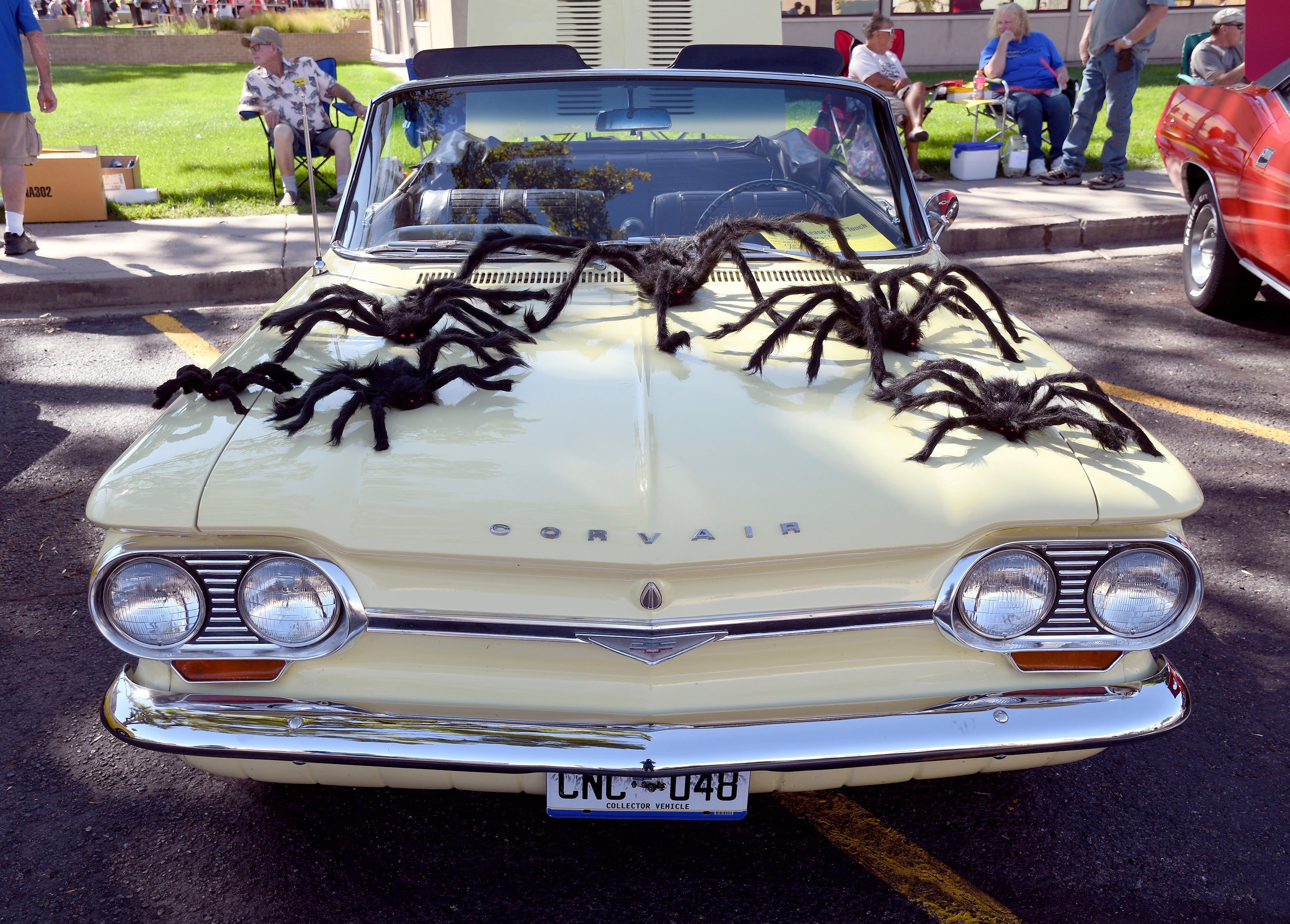 A classic car is decorated with fake spiders at the Tarantula Festival in La Junta