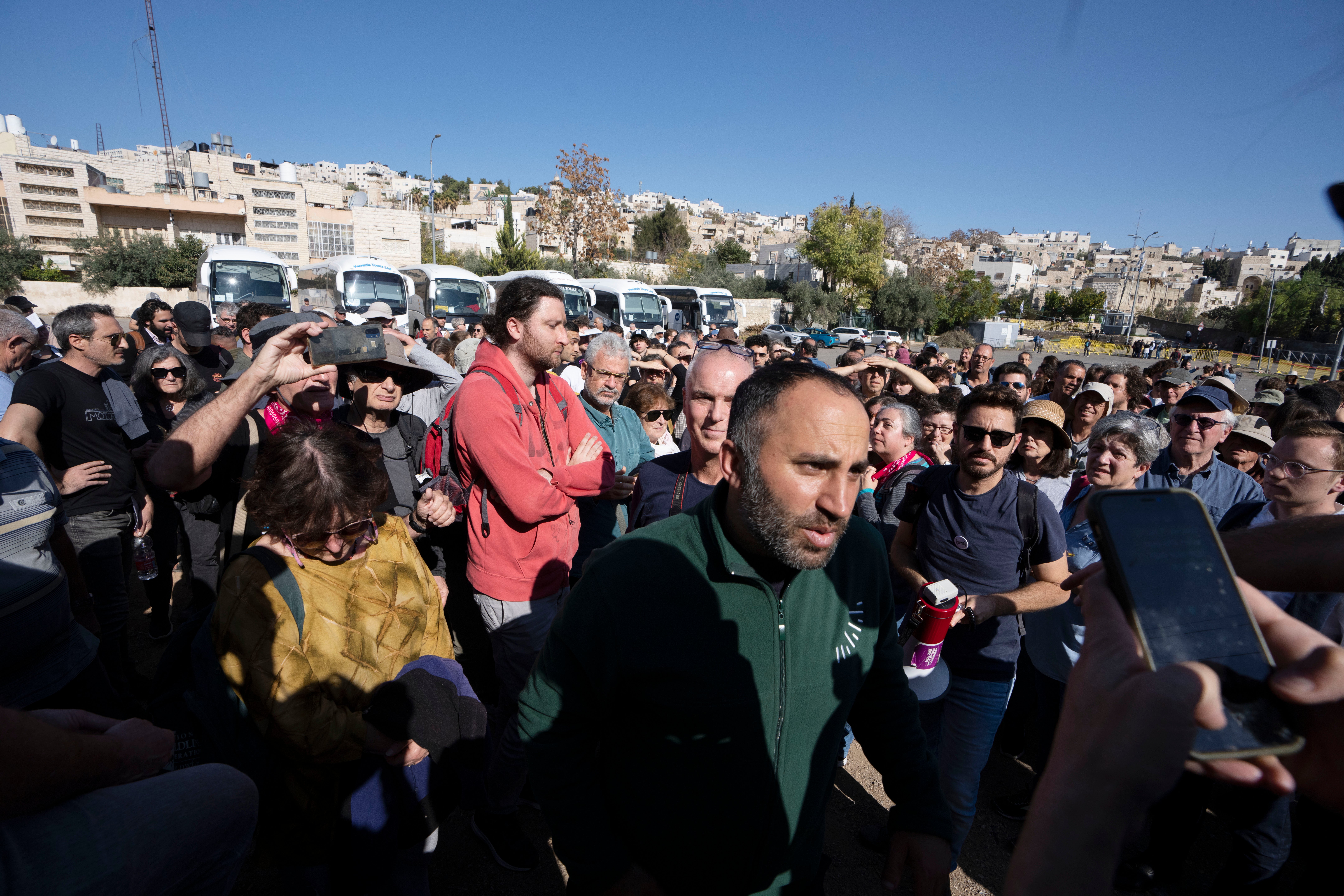 Palestinian activist Issa Amro, front centre, stands with Israeli activists in the embattled West Bank city of Hebron