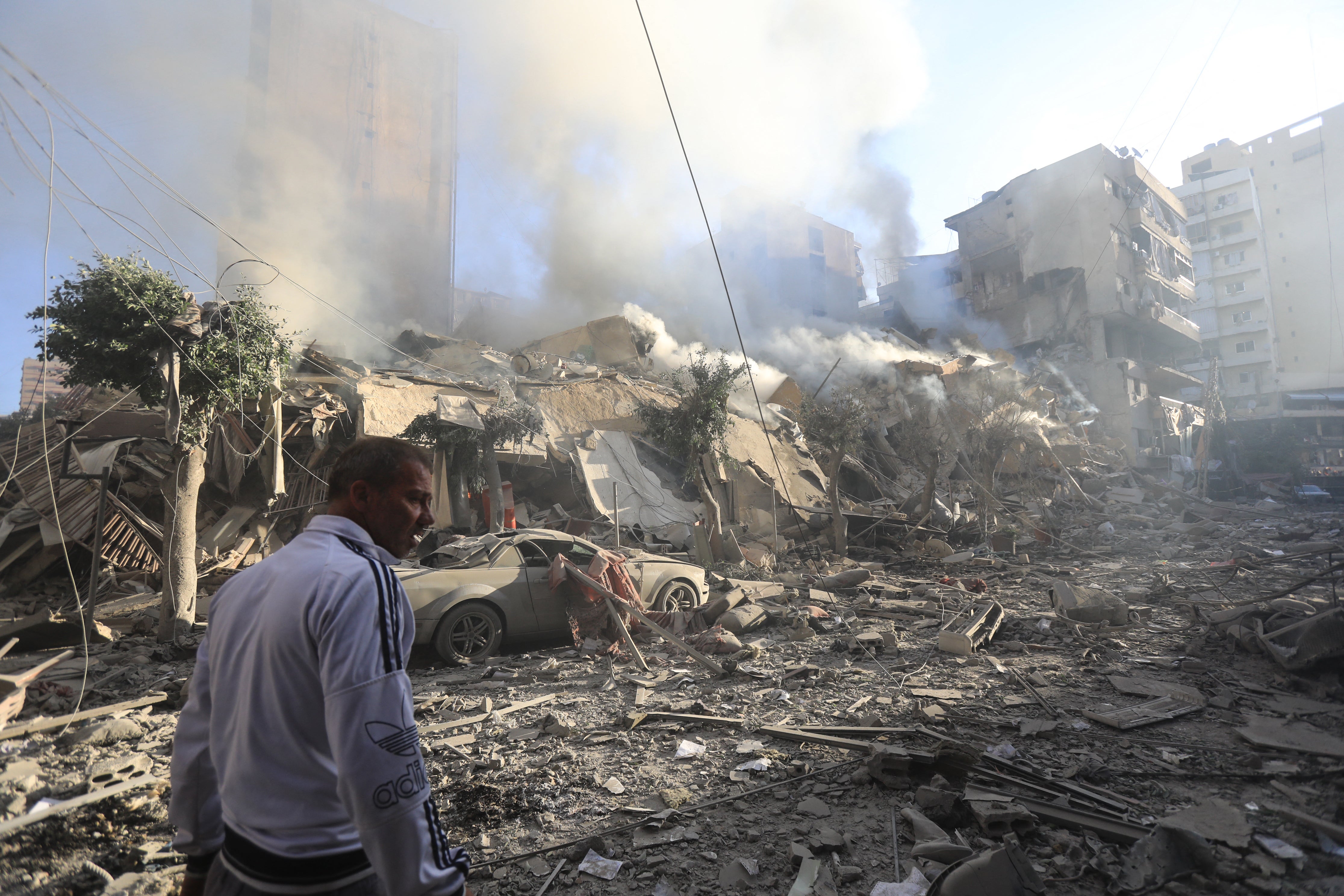 A man walks amid the rubble of a building levelled in an overnight Israeli airstrike