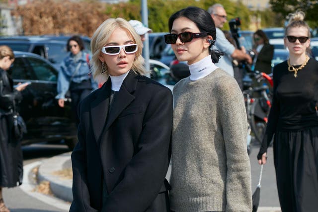 <p>Women walk on street in wool blazer and wool jumper</p>