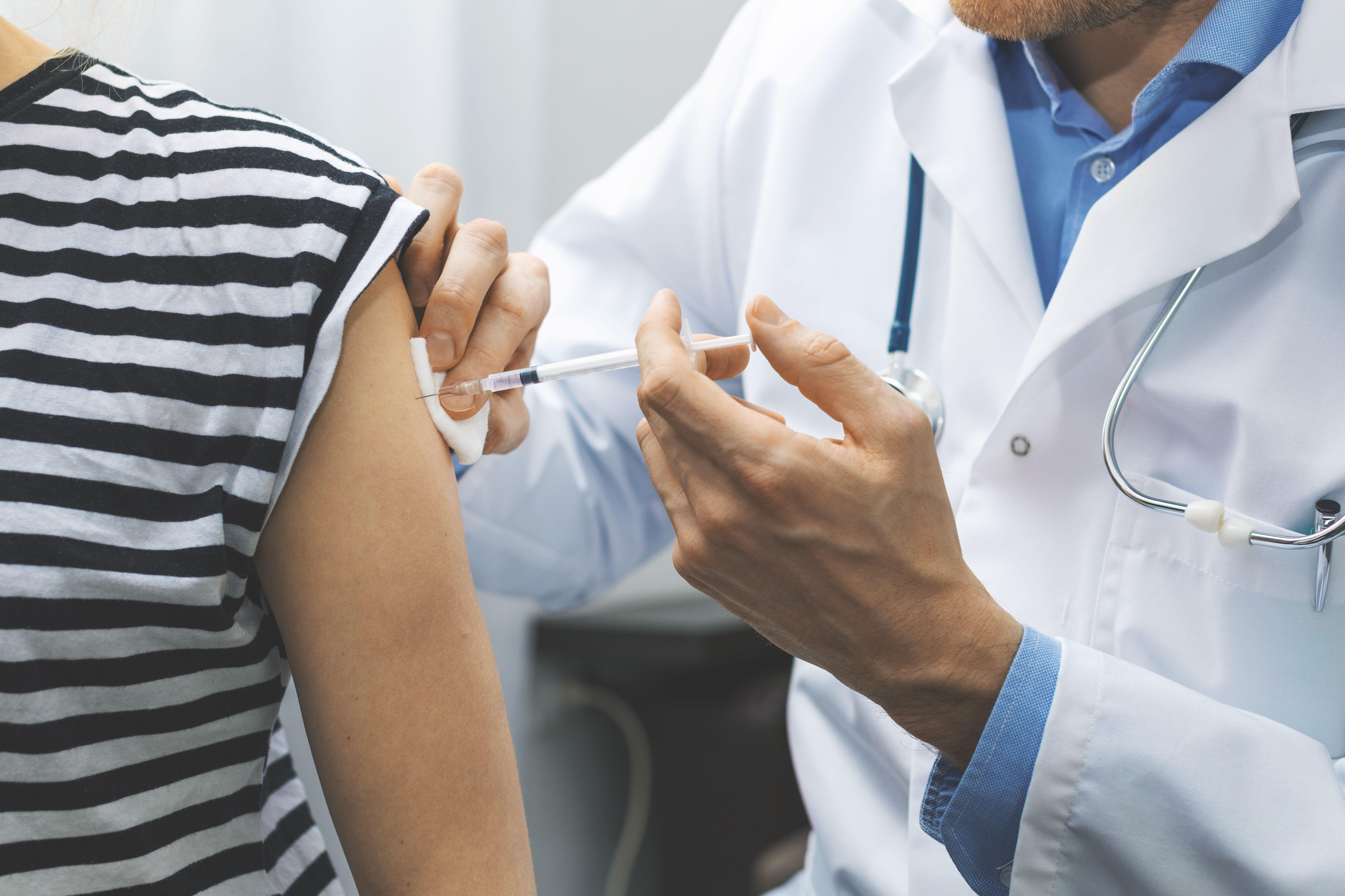 Doctor giving a patient a flu vaccine