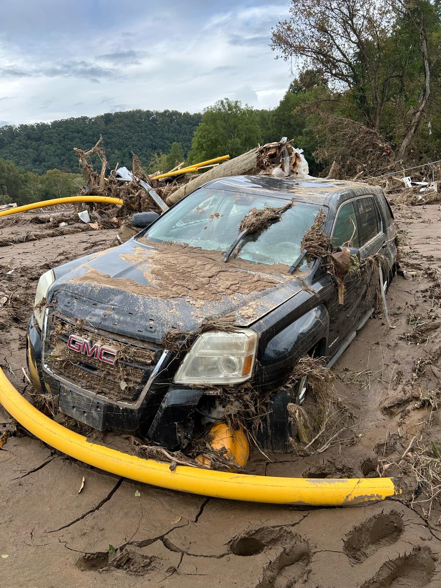 Robert Jarvis’s truck is stuck in the mud after Hurricane Helene brought widespread flooding to northeastern Tennessee.