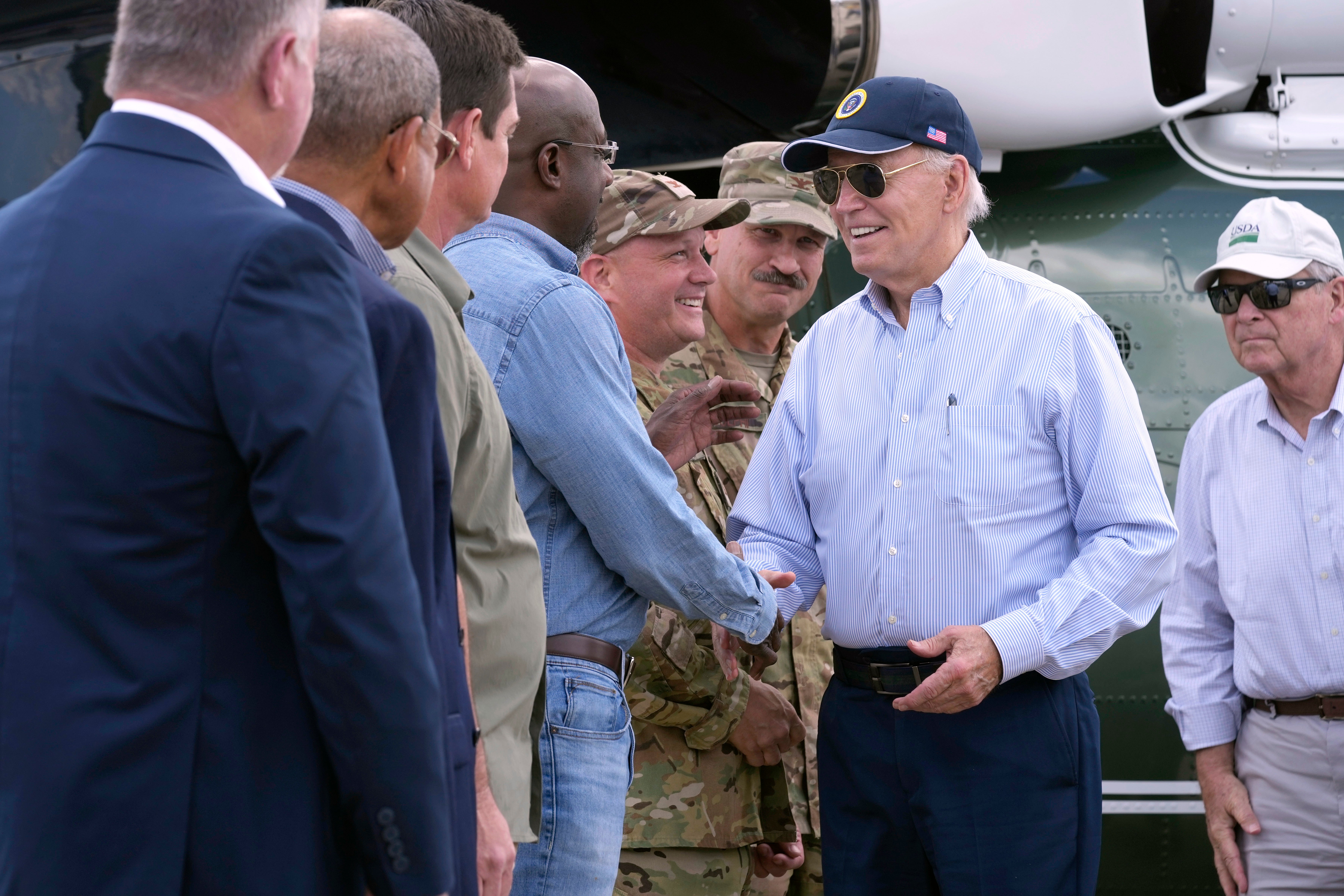 President Joe Biden, right, is greeted by Sen. Raphael Warnock, D-Ga., at Moody Air Force Base, Ga., Thursday, Oct. 3, 2024, during a tour to visit areas damaged by Hurricane Helene. (AP Photo/Susan Walsh)