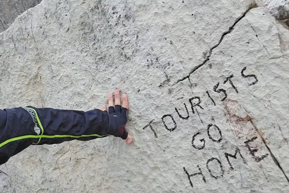 The anti-tourism message was found on a rock in the Dolomites