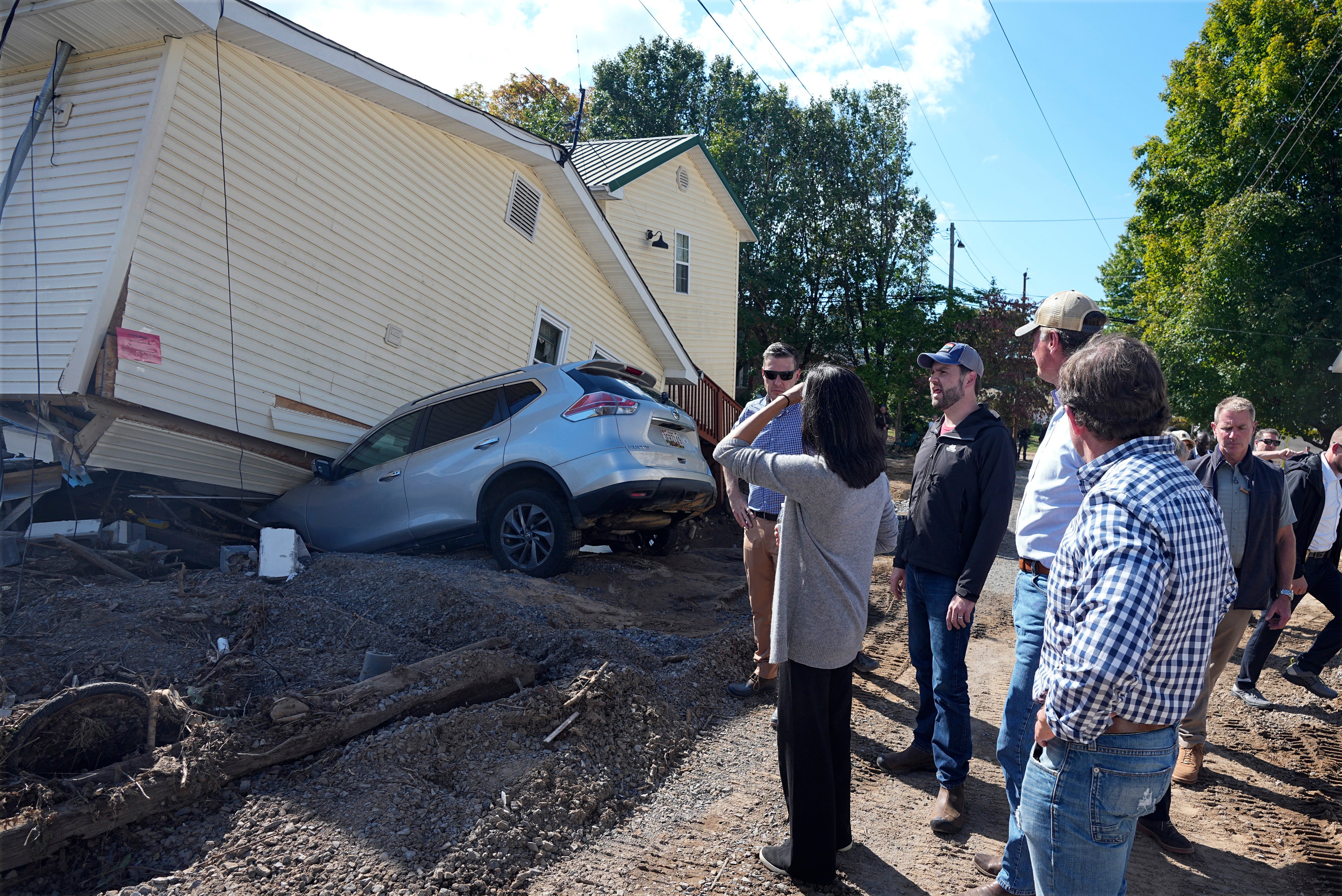 Republican vice presidential nominee Sen. JD Vance, R-Ohio, and his wife Usha Vance, center front, visits areas impacted by Hurricane Helene in Damascus, Va., Thursday Oct. 3, 2024